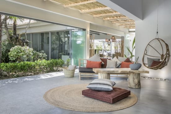 a living room with a large glass wall and a round table