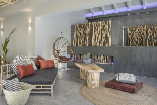 a room with a couch and chairs