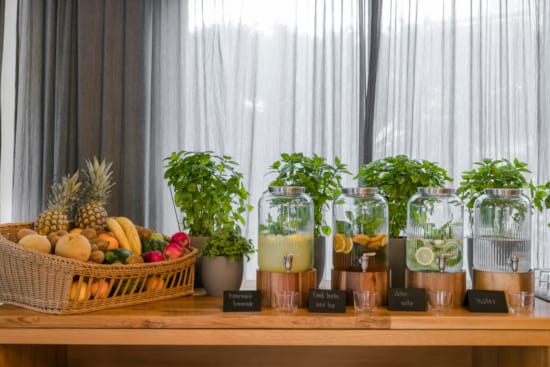 a table with a basket of fruit and plants
