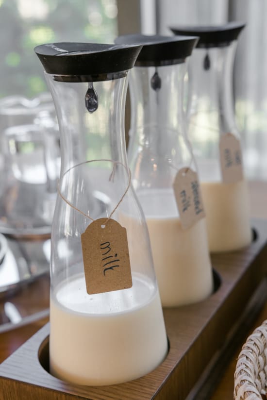 a group of glass jars with white liquid in them