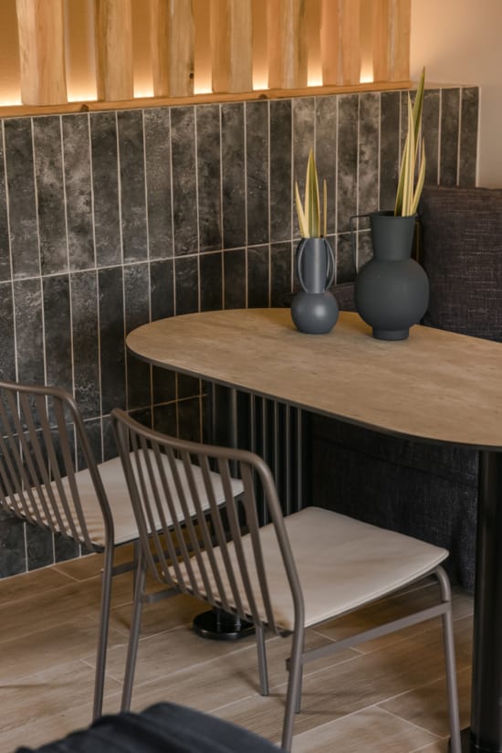 a table with chairs and a vase on it