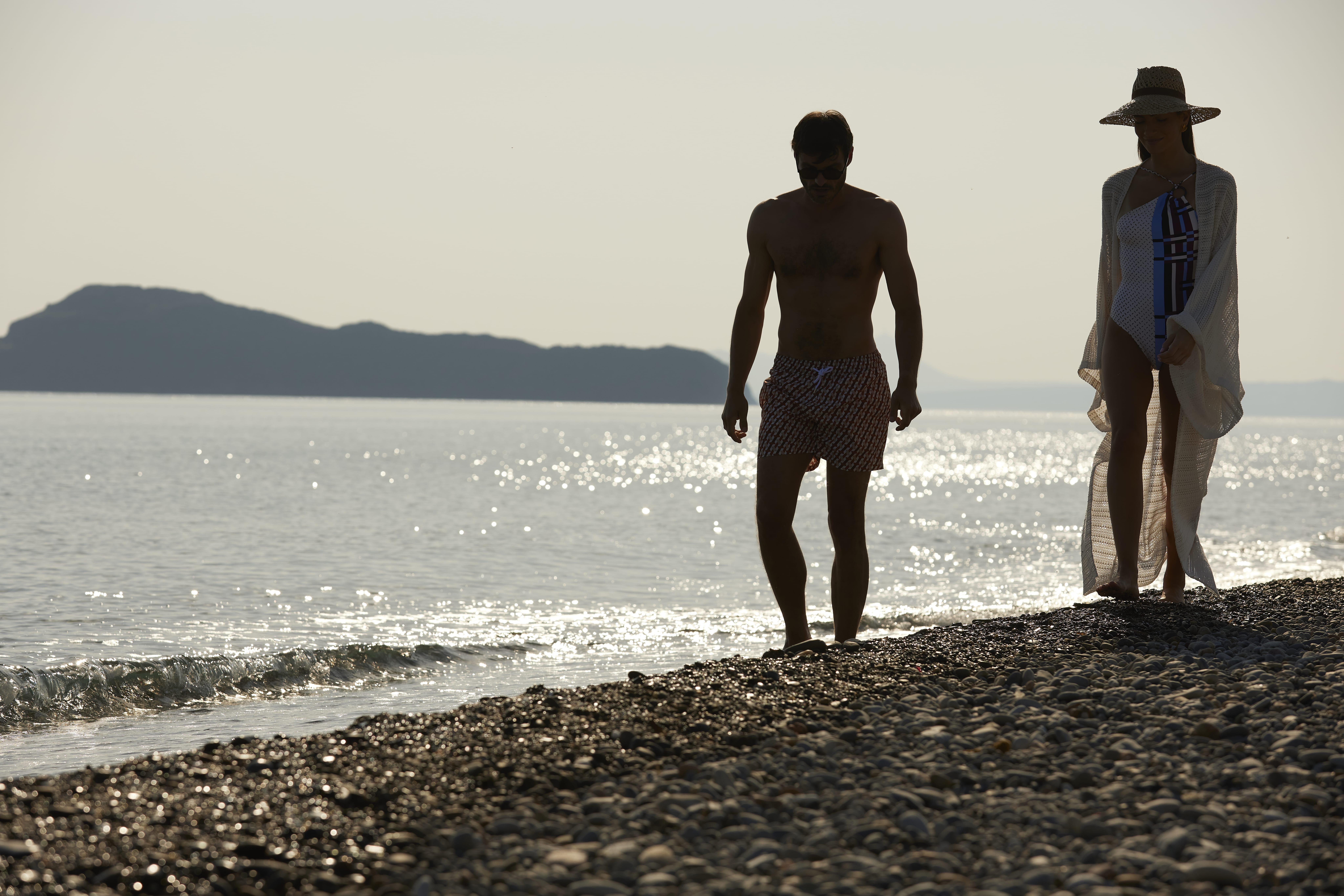 two men standing on a beach