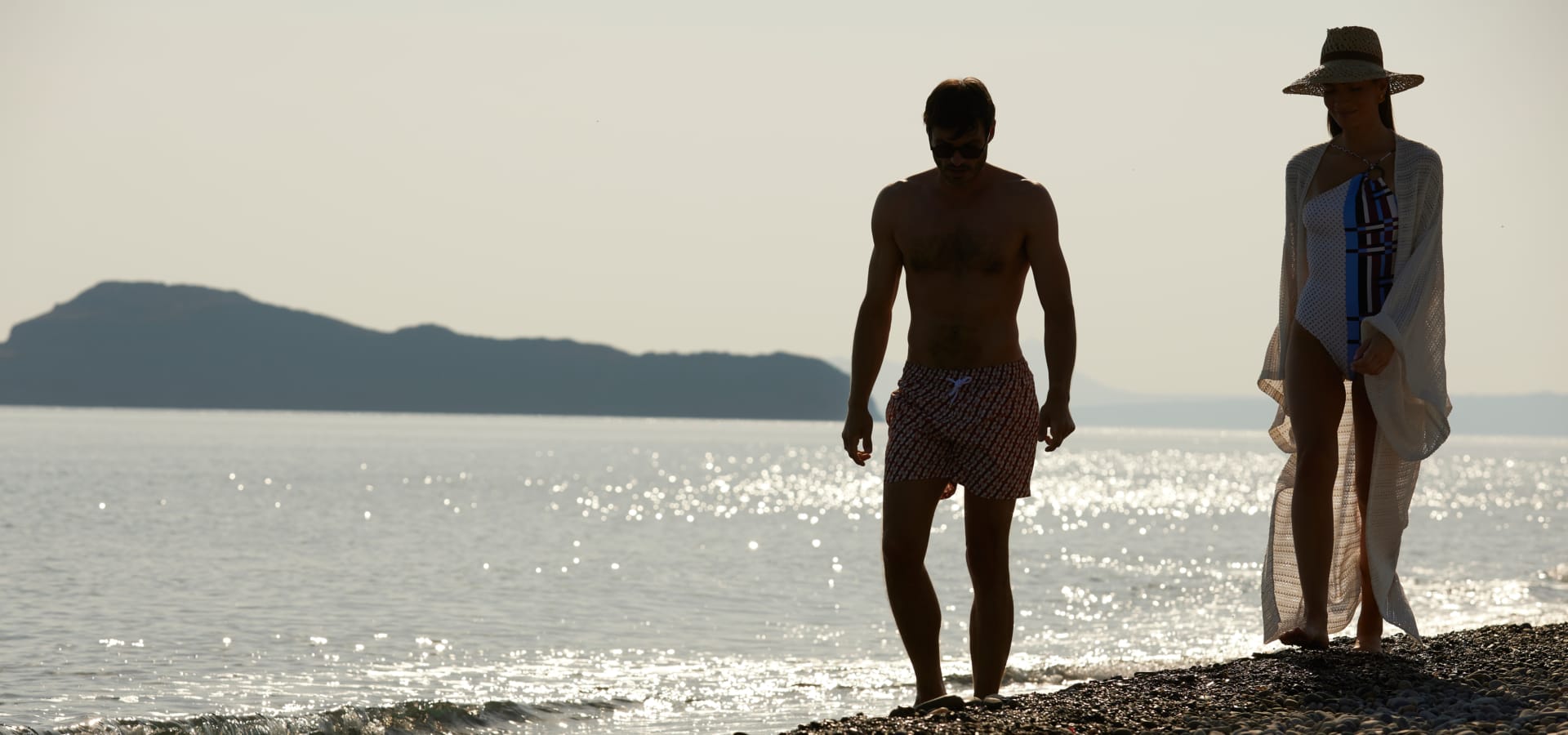 two men standing on a beach