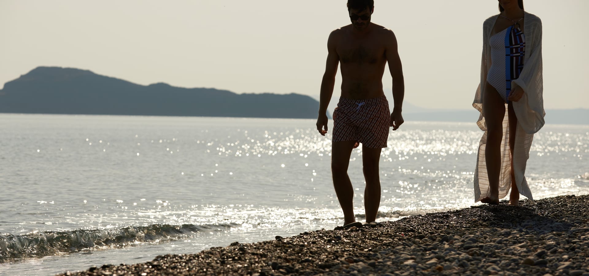 two men standing on a beach
