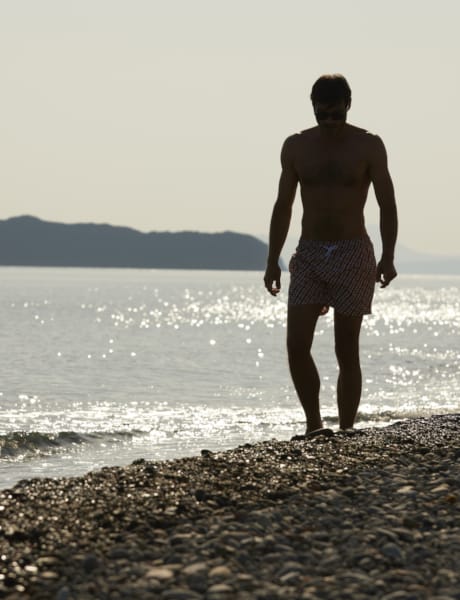 two men standing on a beach
