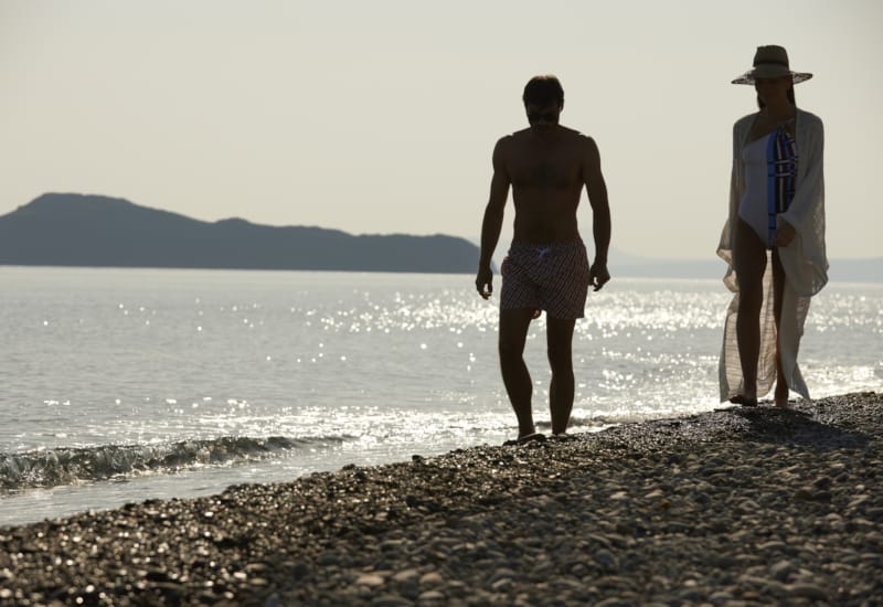 two men standing on a beach