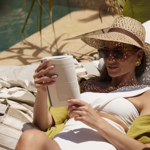 a person in a hat holding a cup