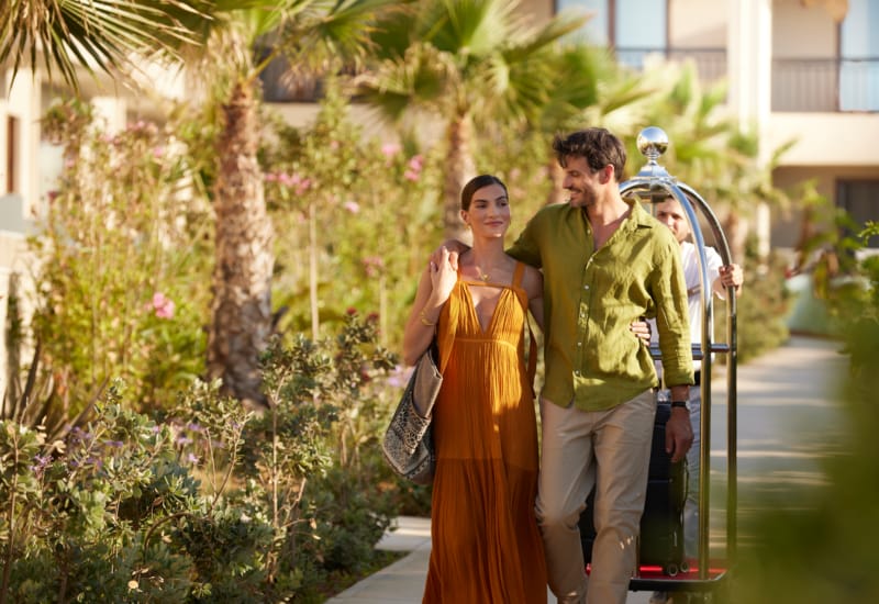 a man and woman walking down a sidewalk