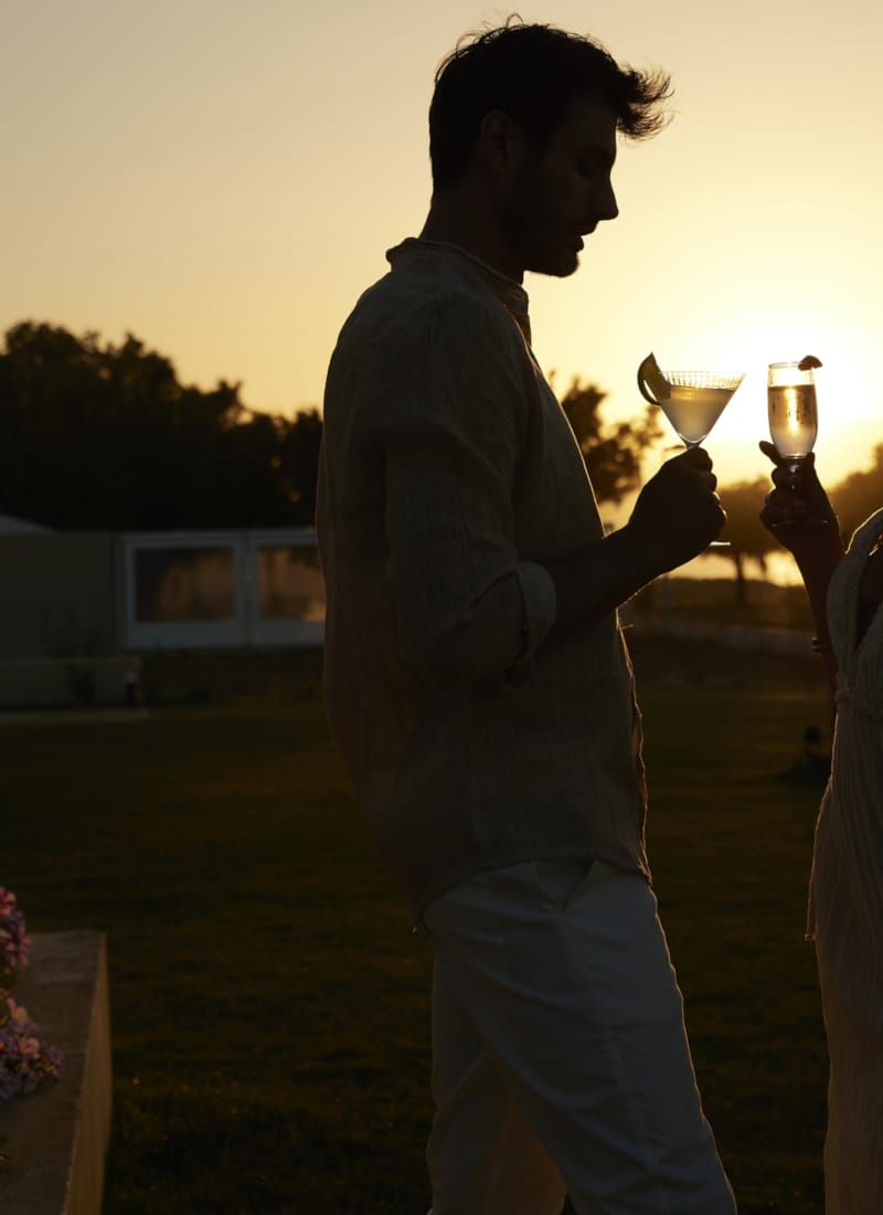 a man and woman holding wine glasses