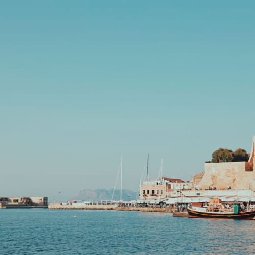 a body of water with boats and buildings along it