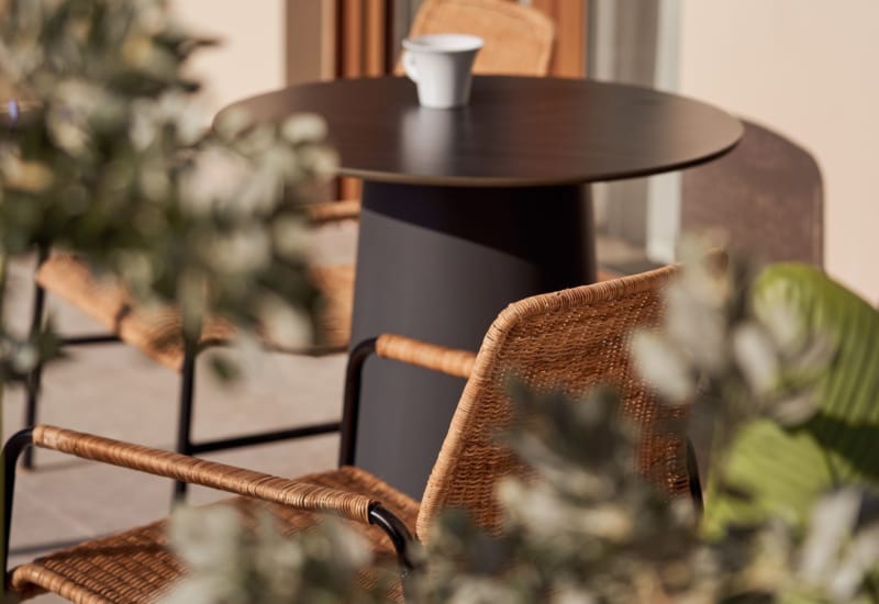 a table with a chair and flowers