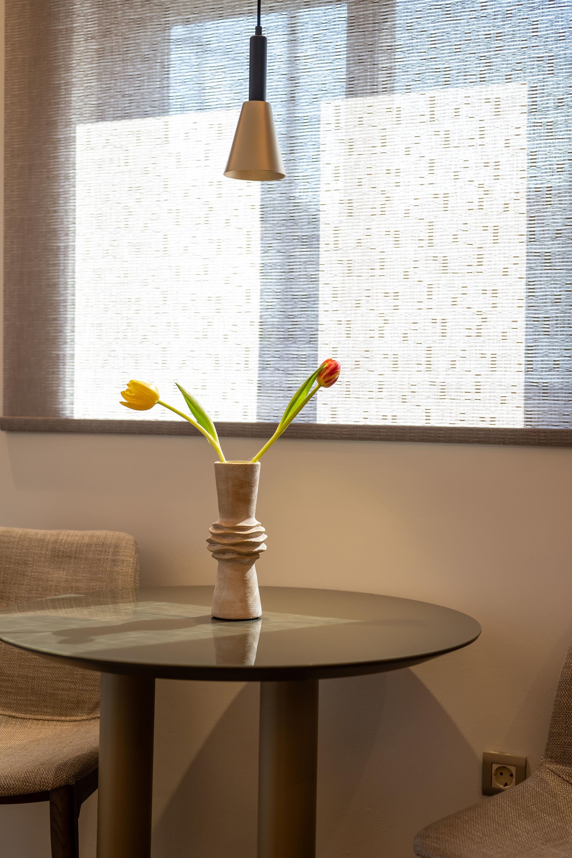 a vase with flowers on a table