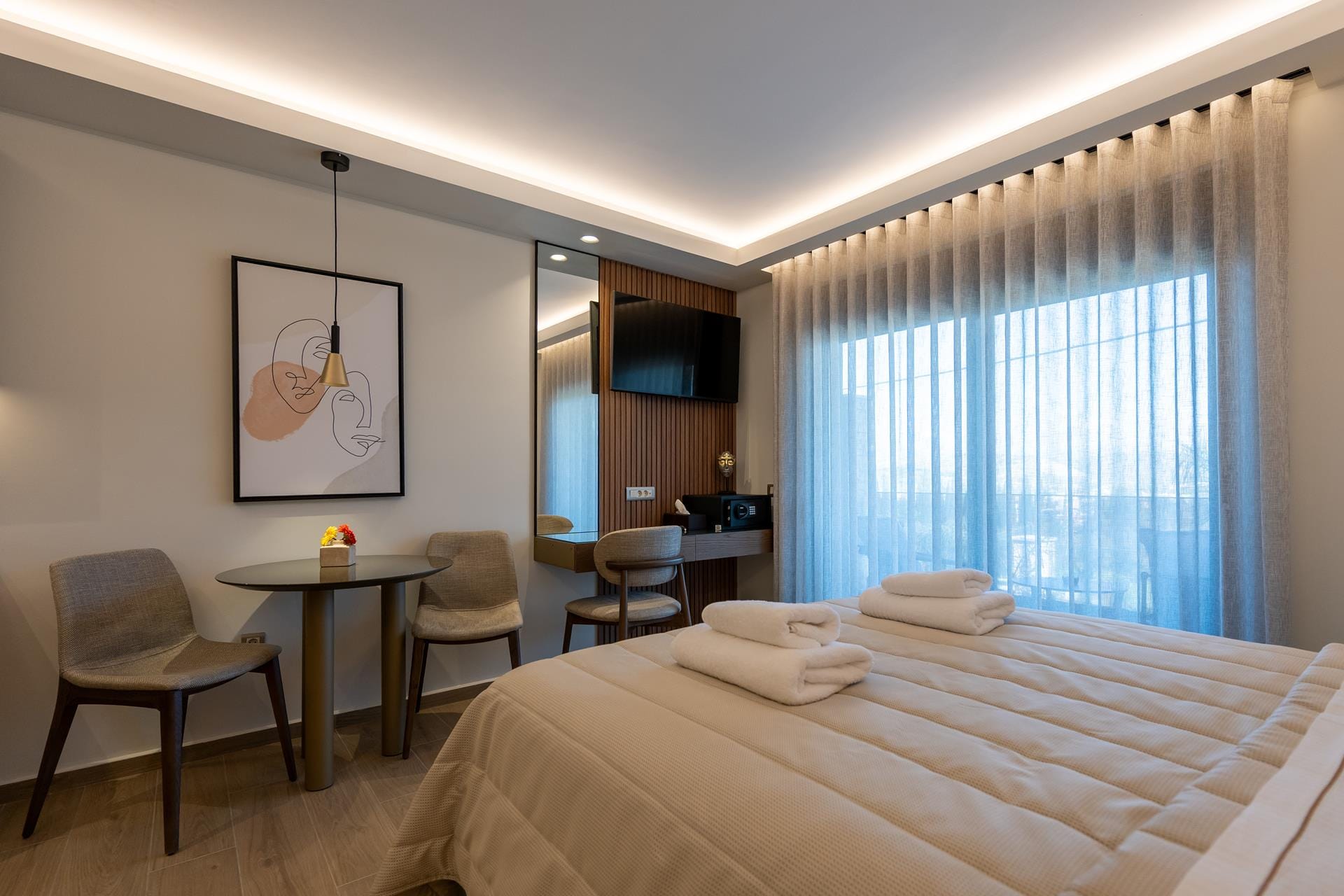 a hotel room with a bed and chairs