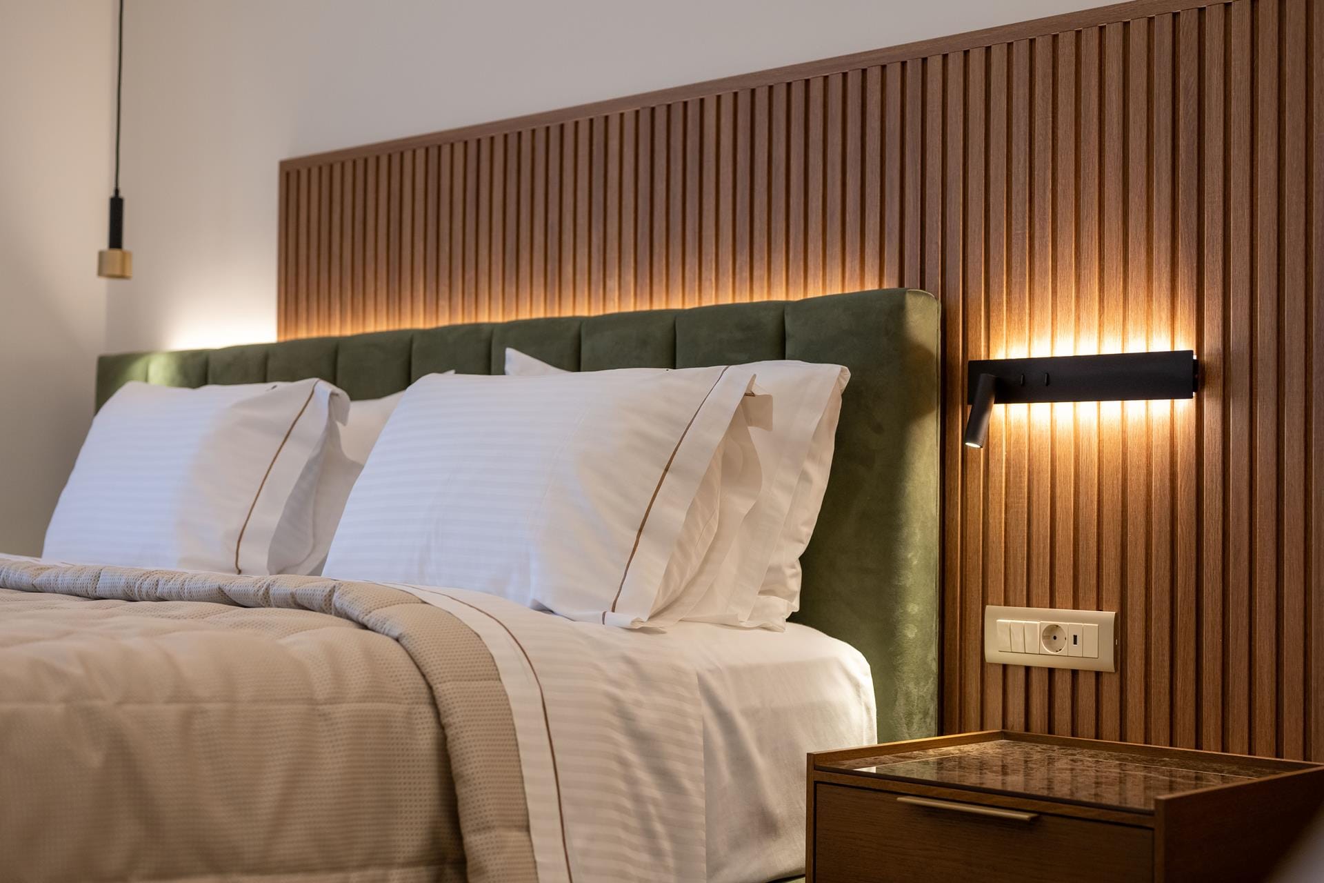 a bed with a green headboard