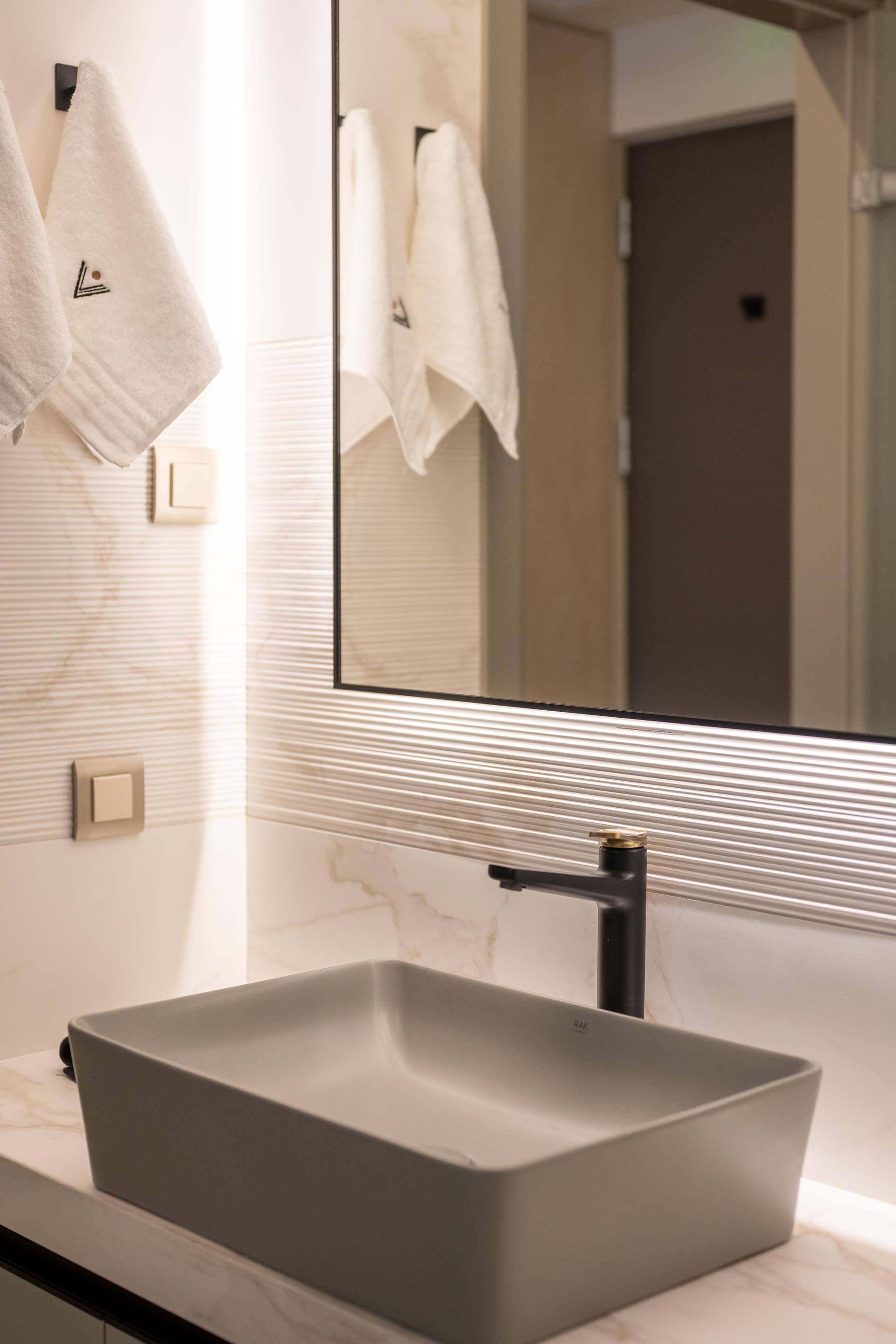 a bathroom sink with a mirror above it