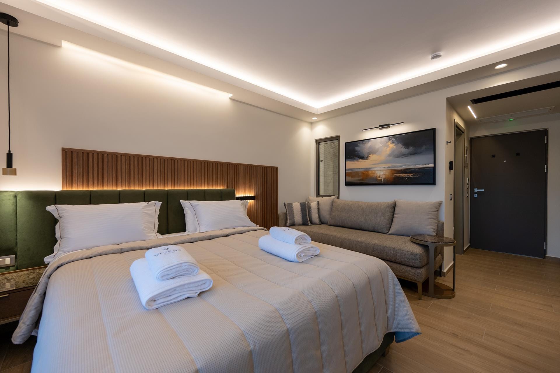 a hotel room with a bed and couches