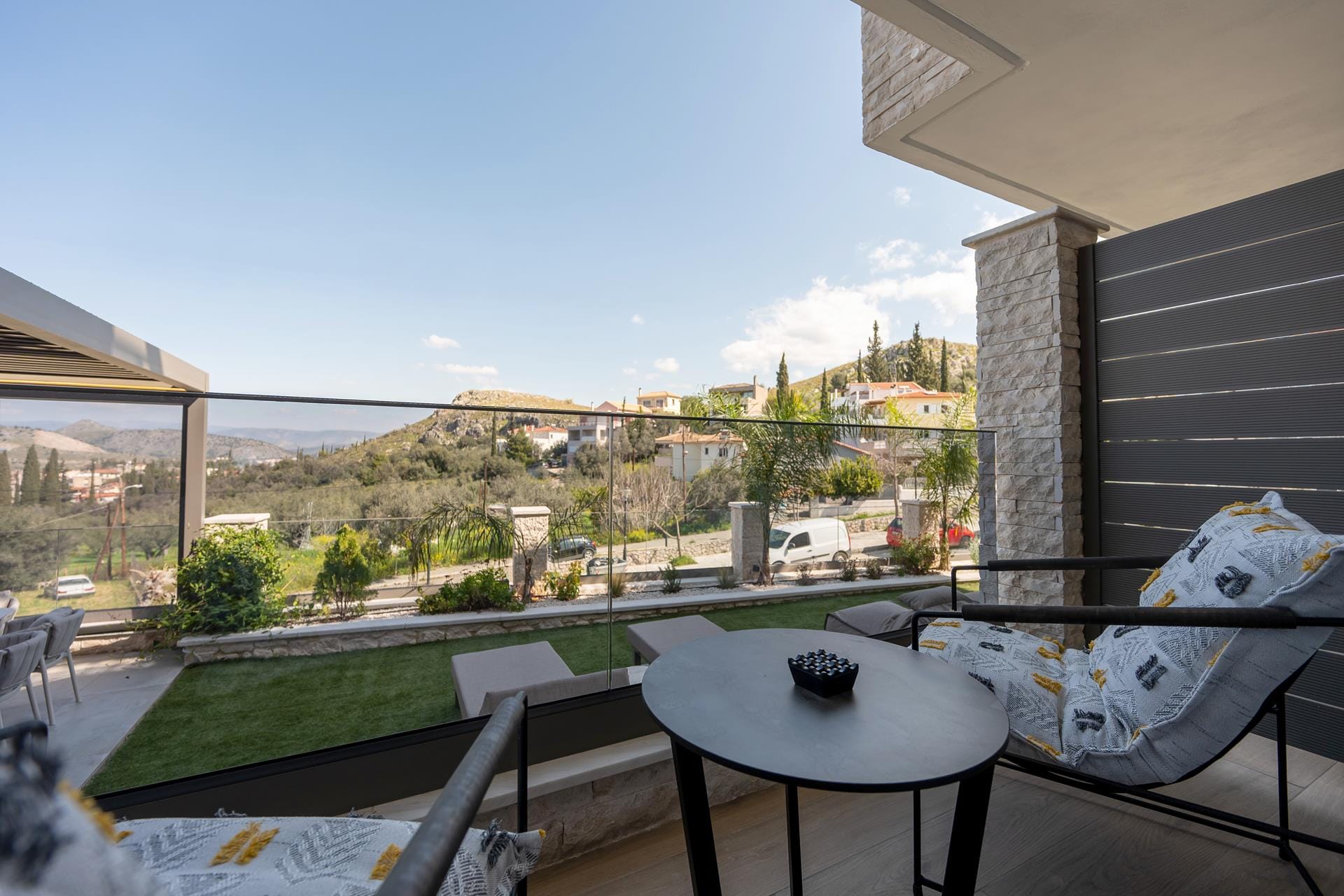 a balcony with a view of a city and trees