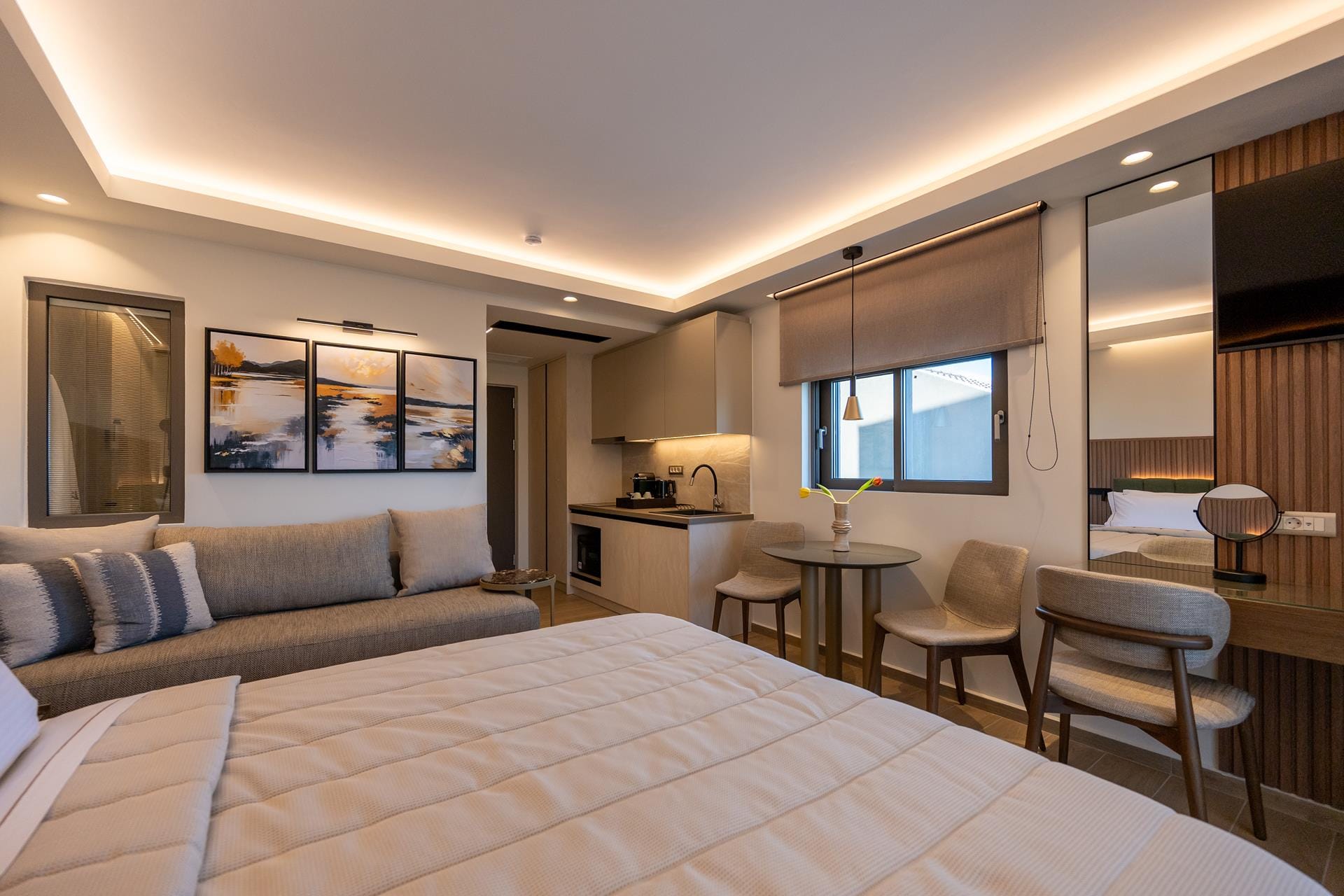 a room with a bed and chairs