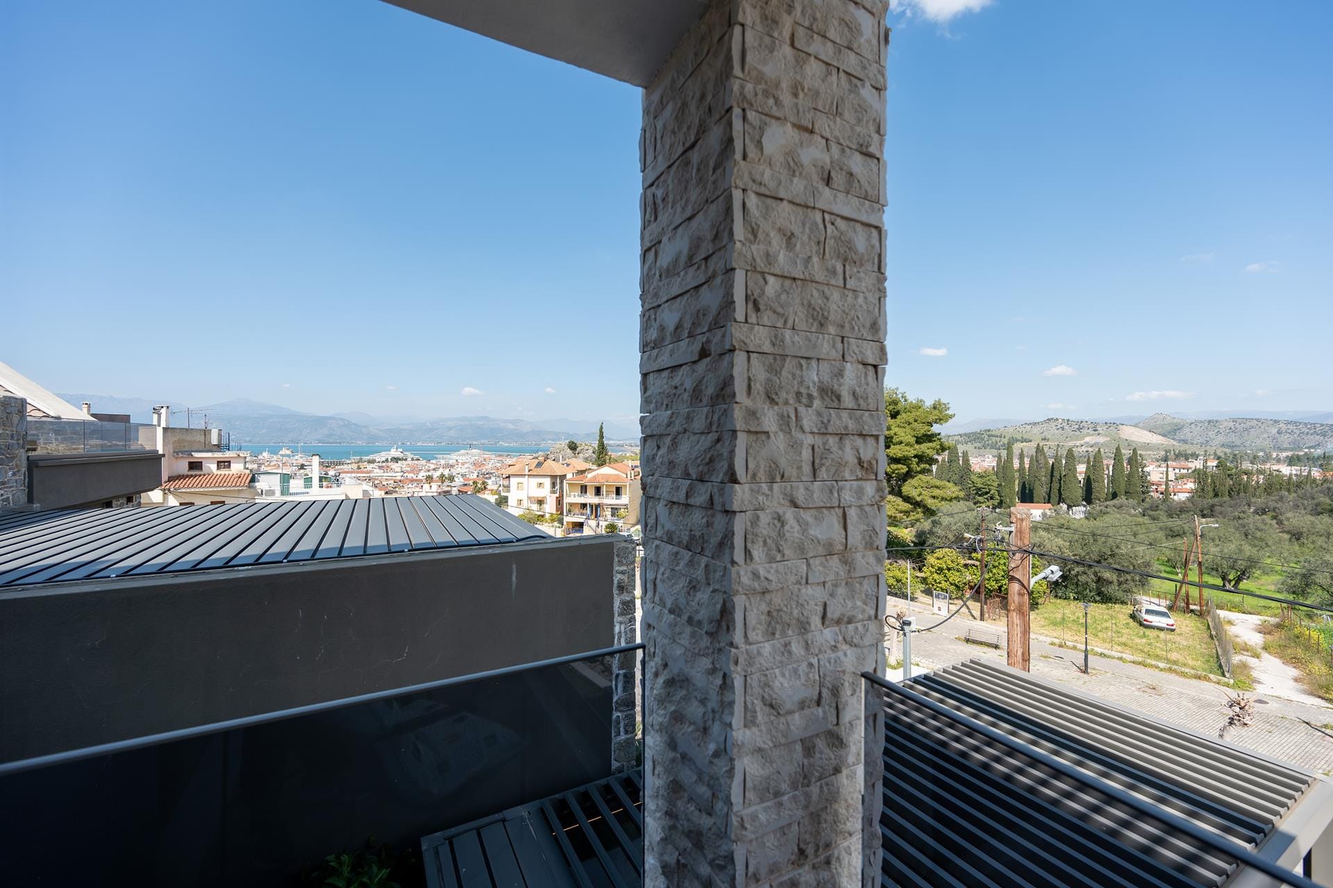 a stone column with a city in the background