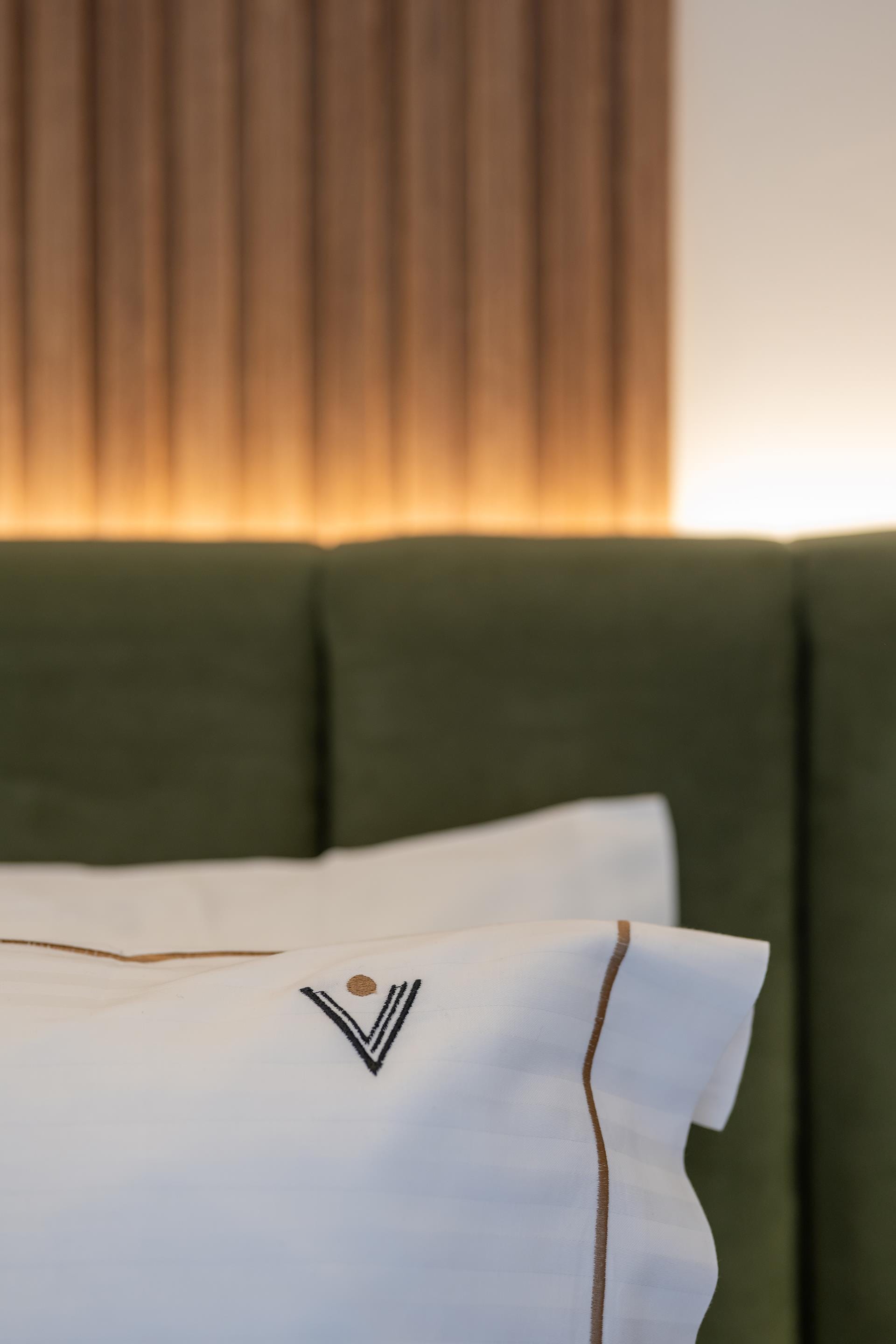 a green couch with a white pillow