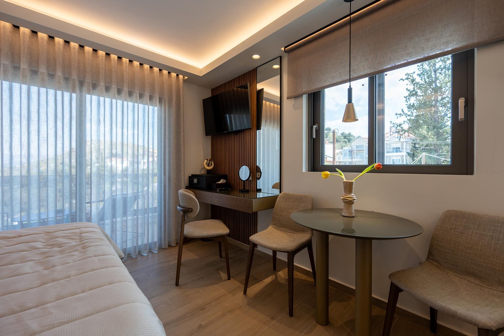 a room with a bed desk and chairs