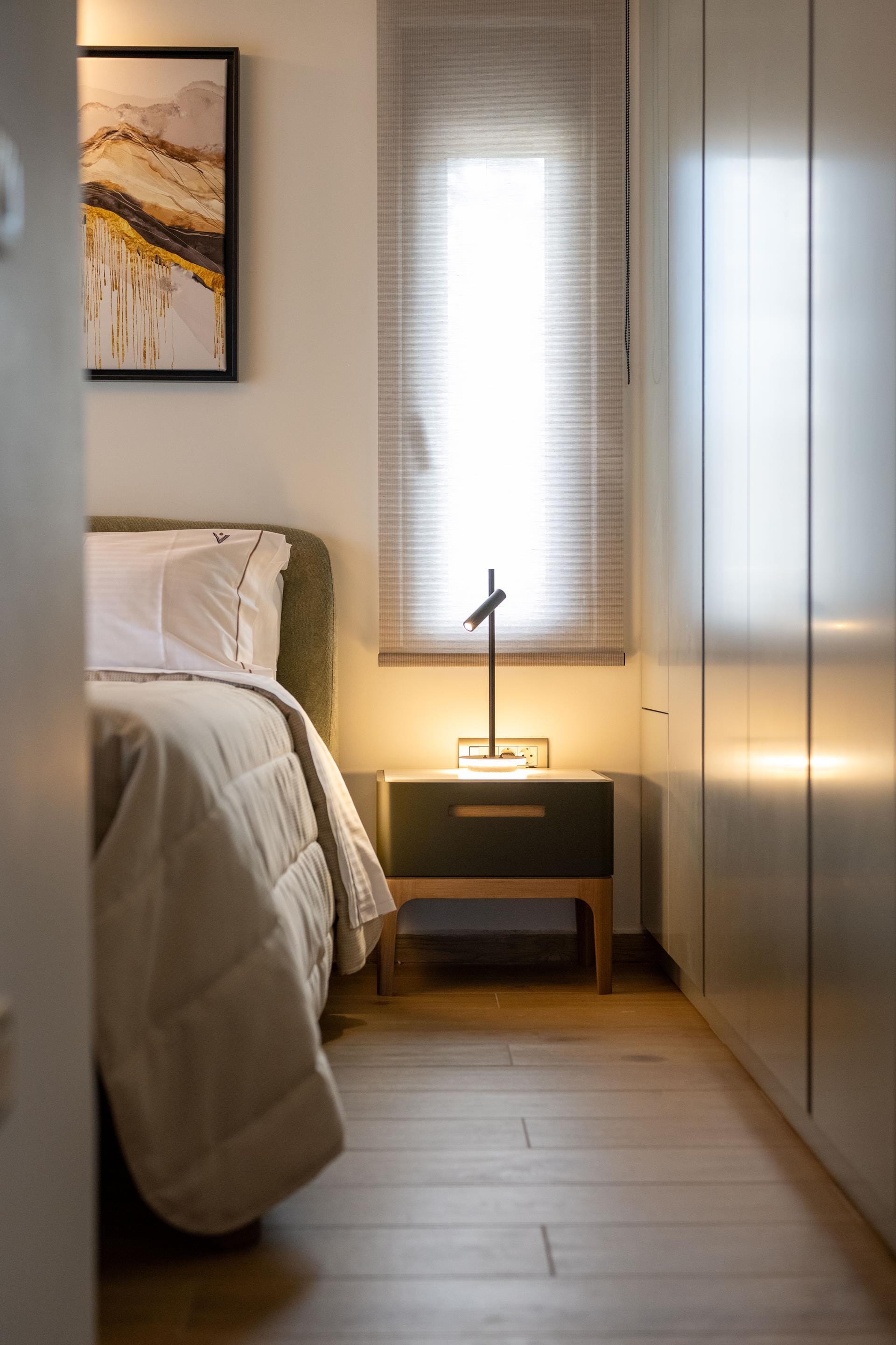 a bedroom with a bed and a desk