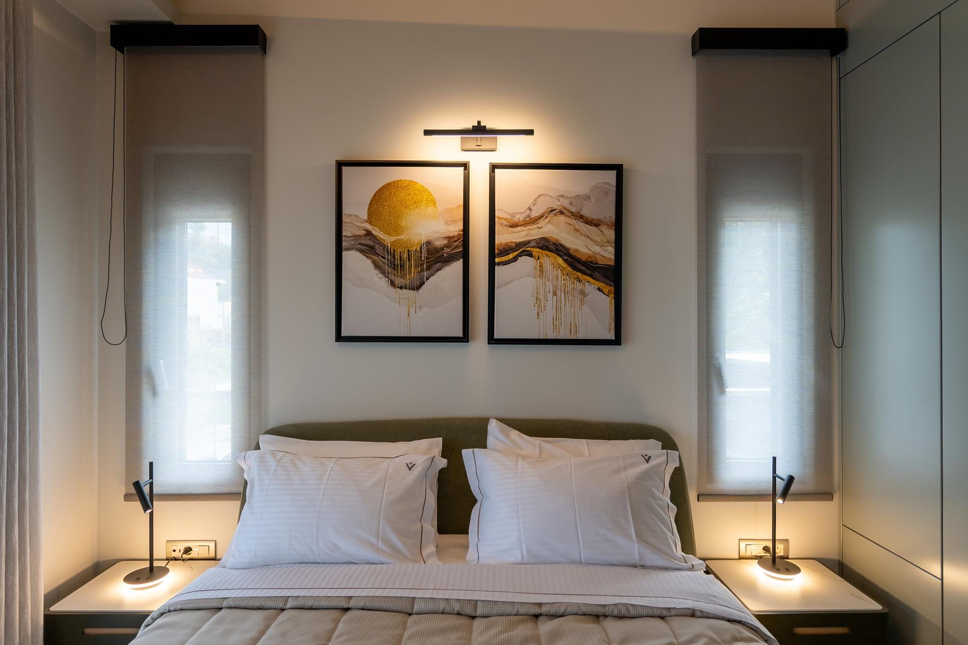 a bedroom with a large painting on the wall