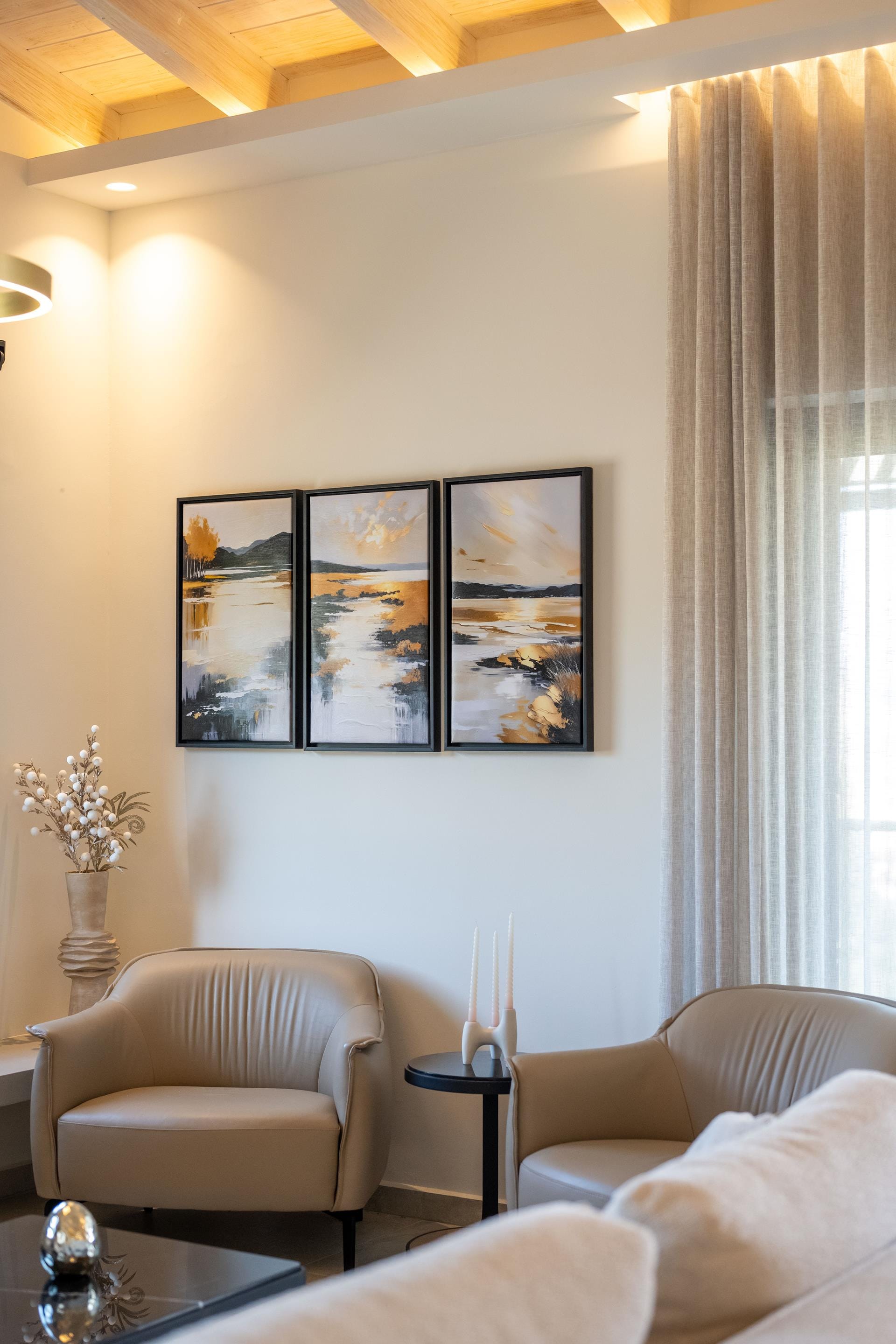 a room with a white couch and a table with a white chair