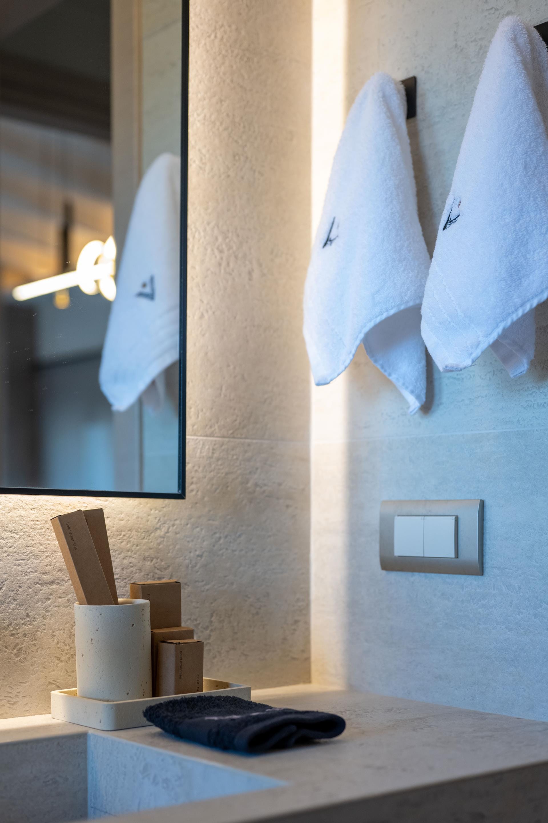 a mirror and a towel on a wall