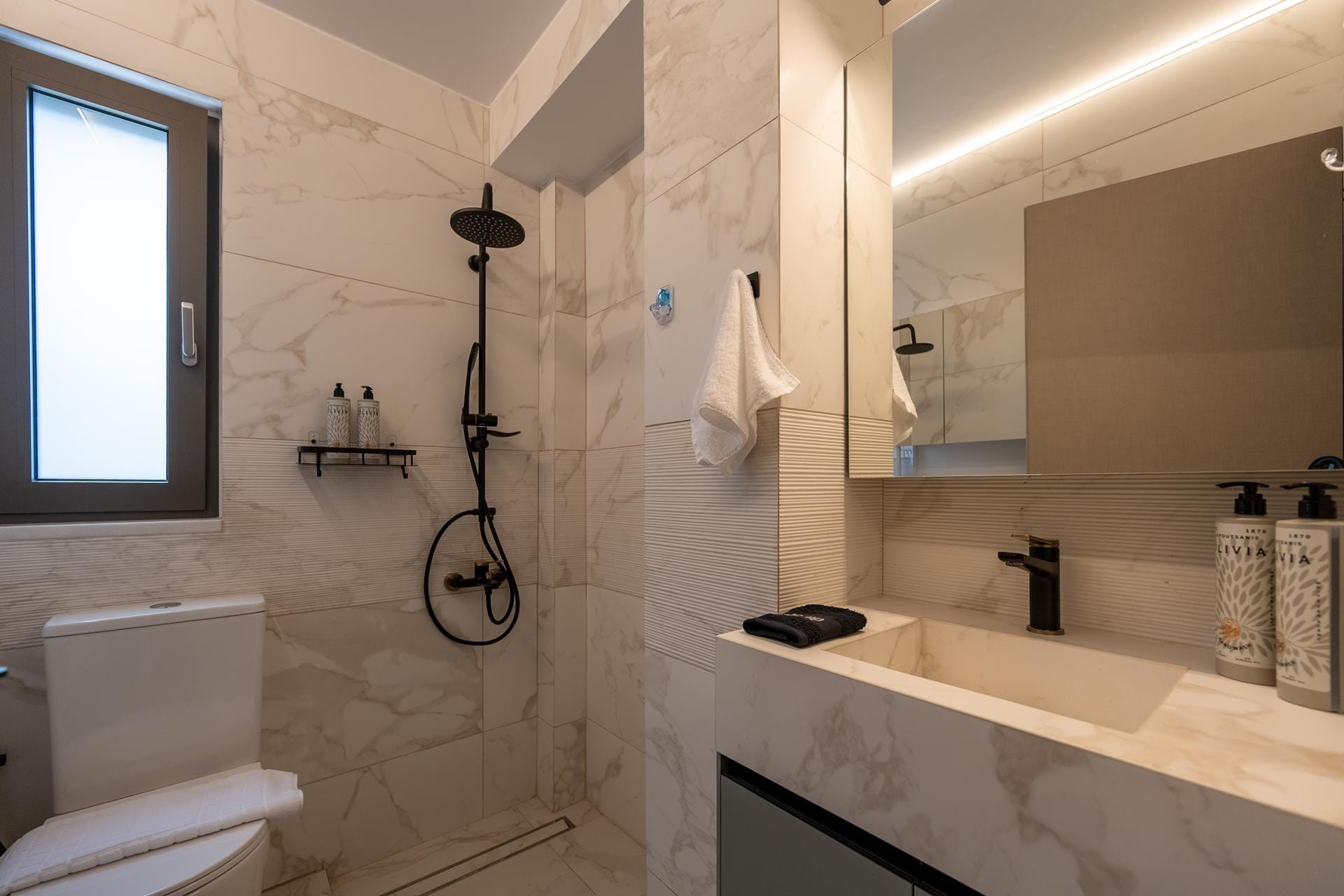 a bathroom with a sink toilet and mirror