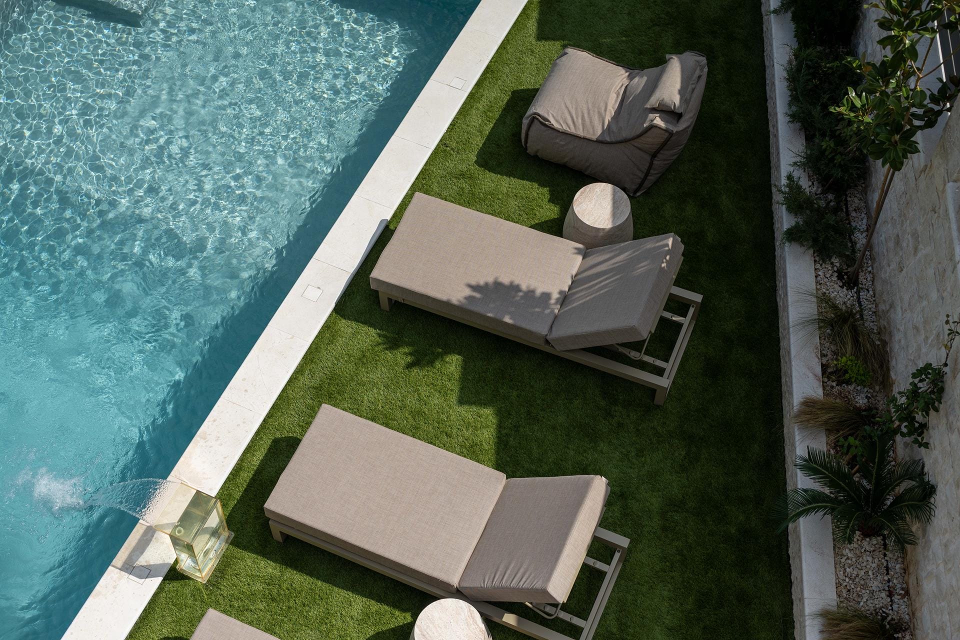 a chair and a table by a pool