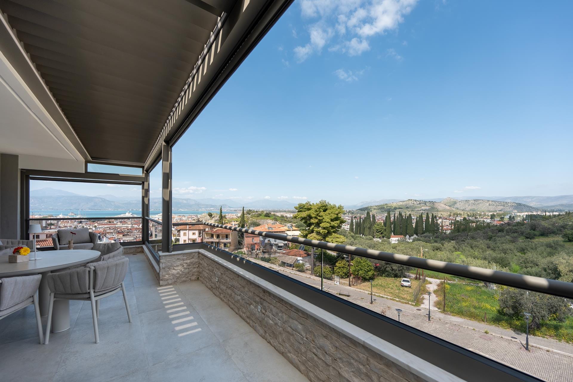 a deck with a view of a city and trees