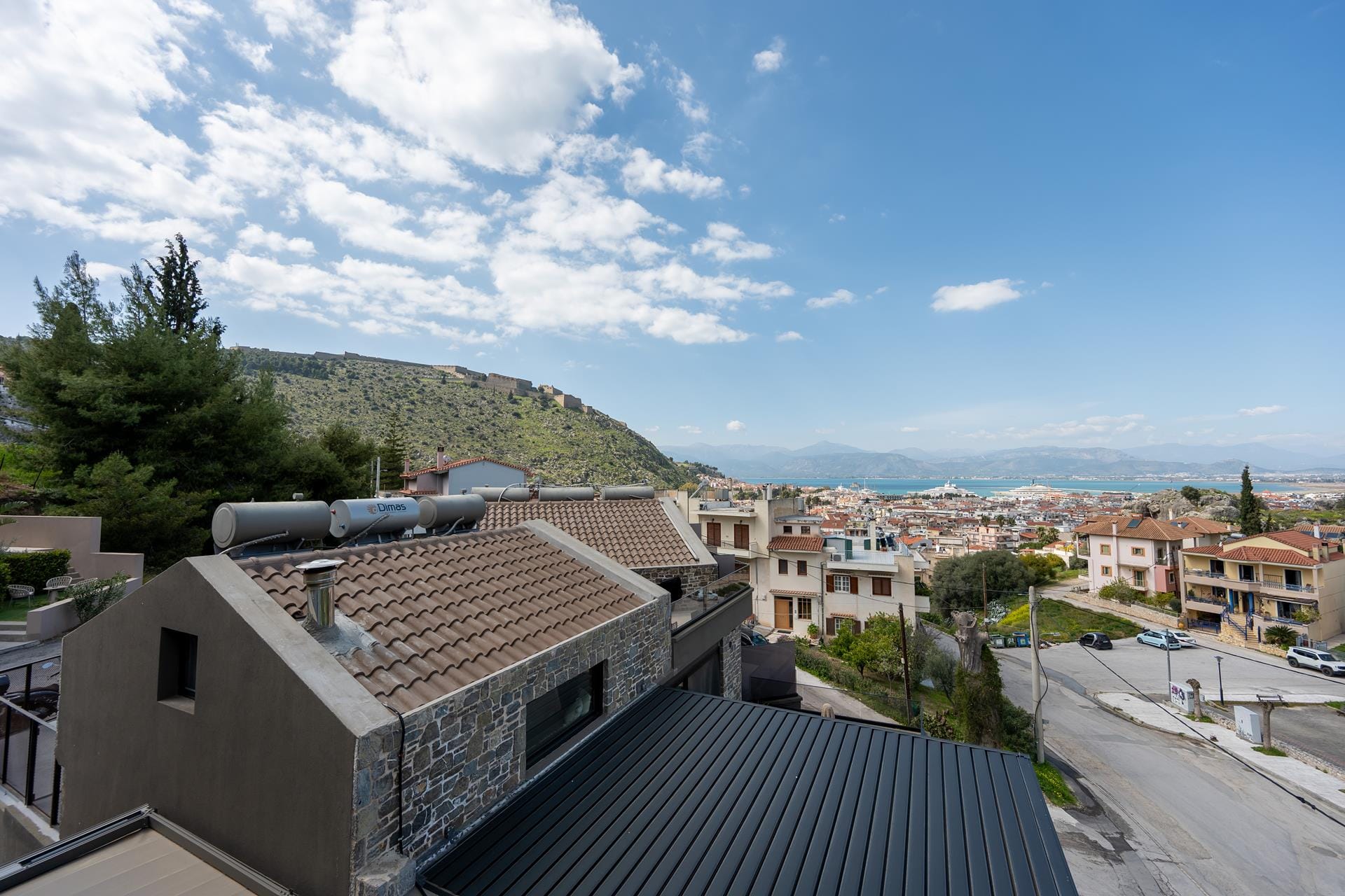 a rooftop of a building with a hill in the background