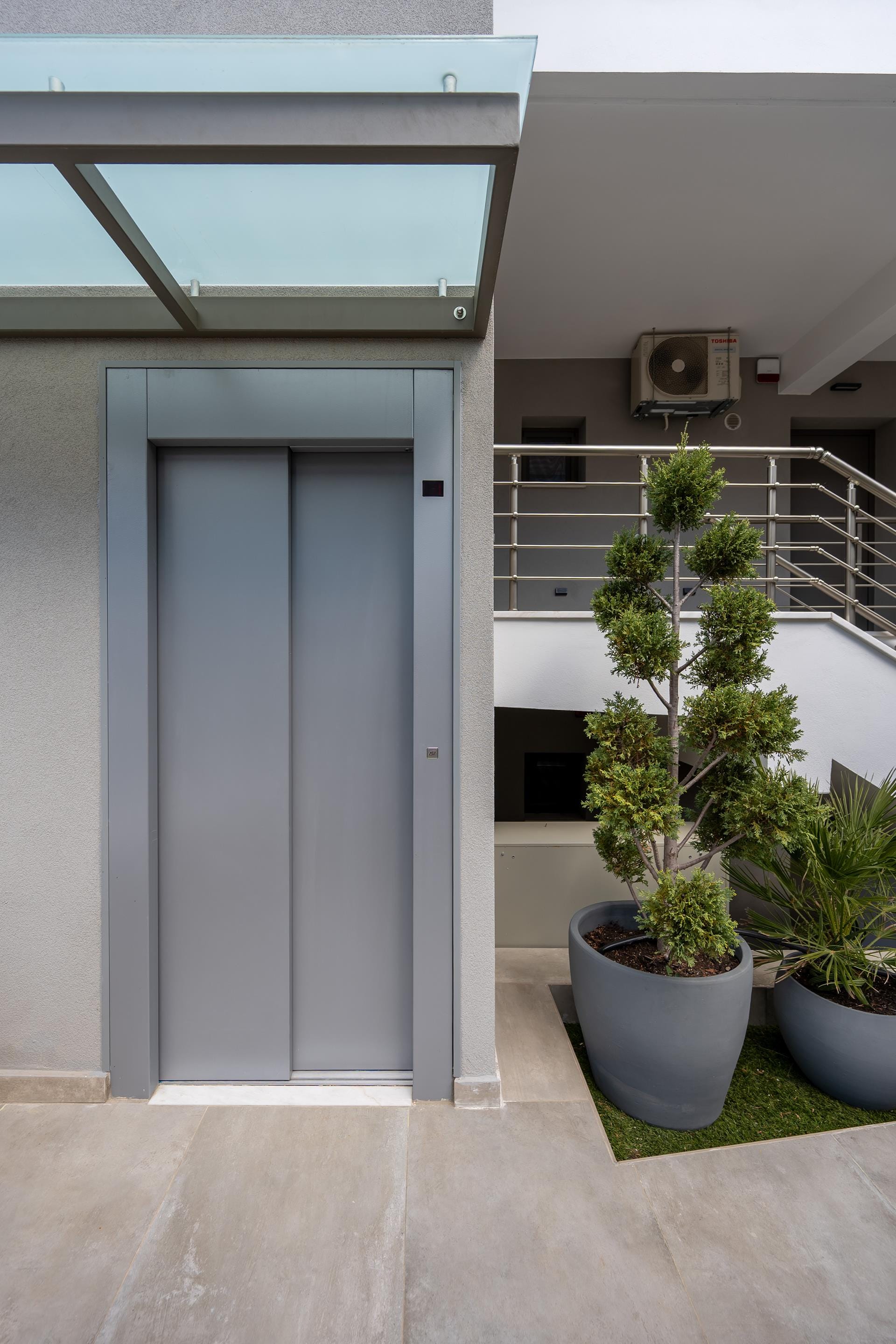 a white door with a plant in front of it