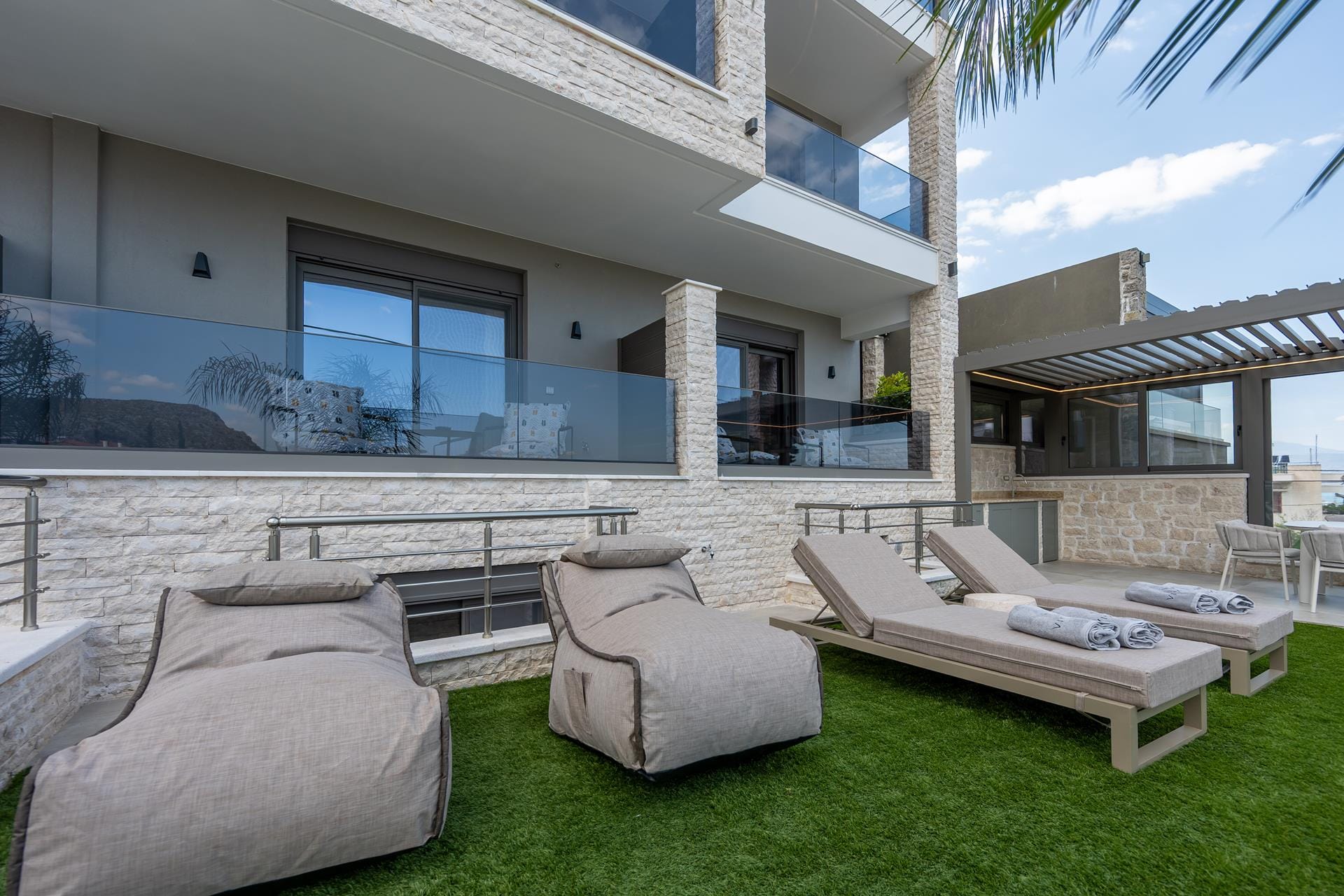 a living room with a pool and lounge chairs