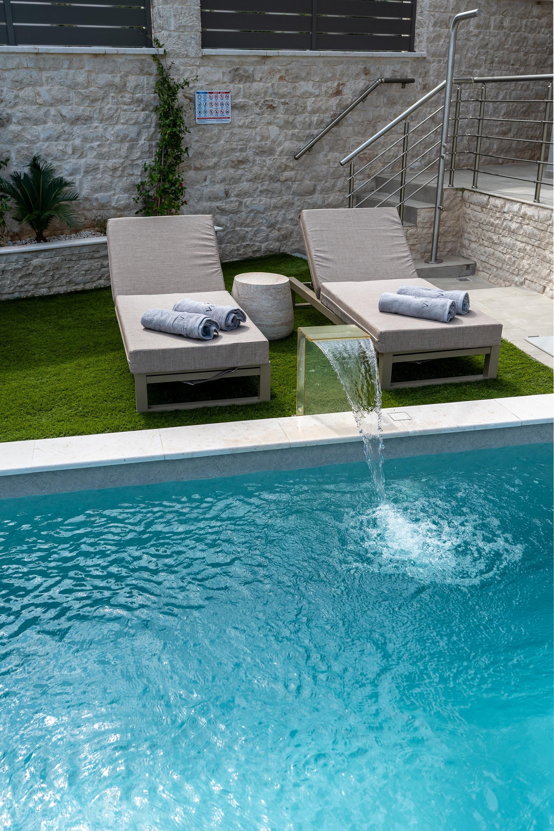 a couple of chairs by a pool