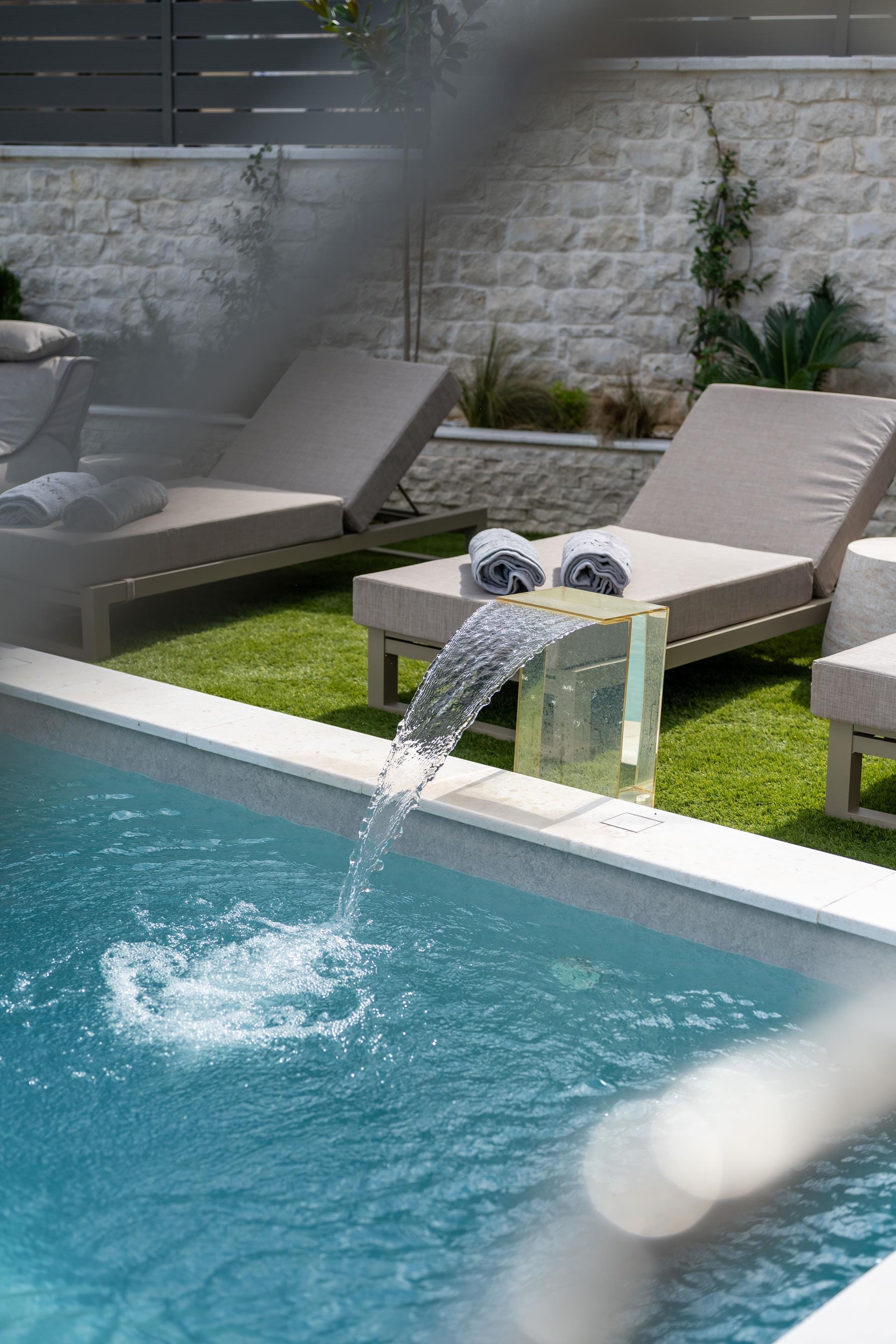 a pool with a chair and a table by it