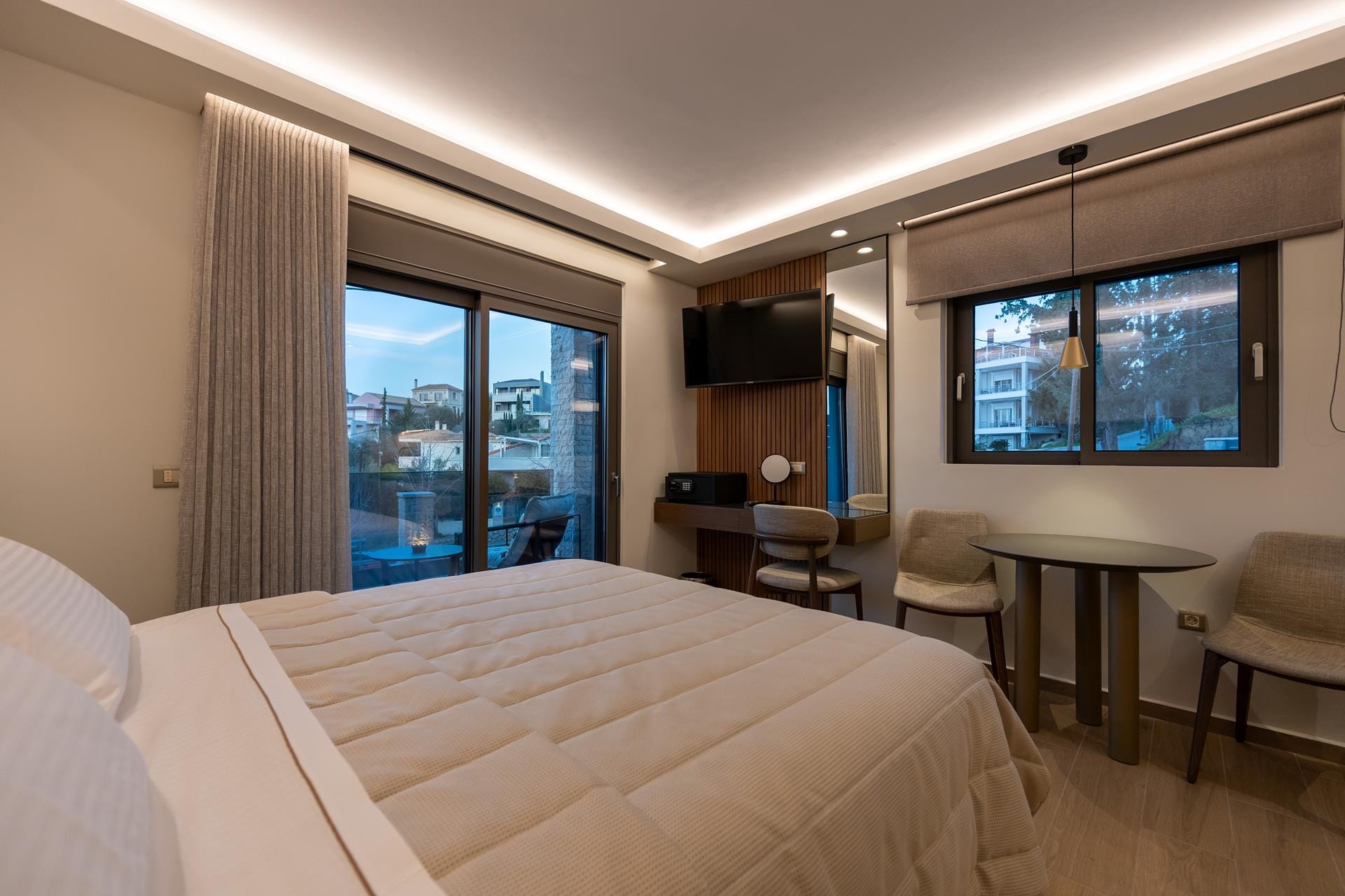 a hotel room with a bed and chairs