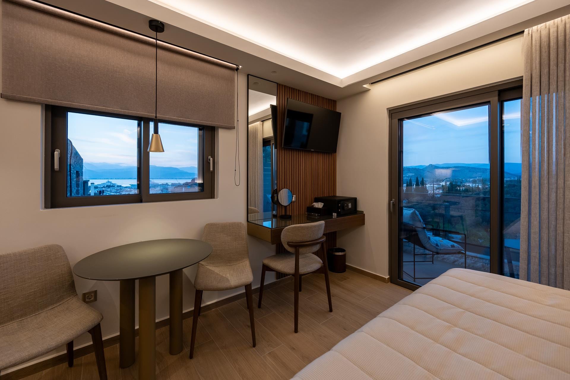 a room with a bed and chairs