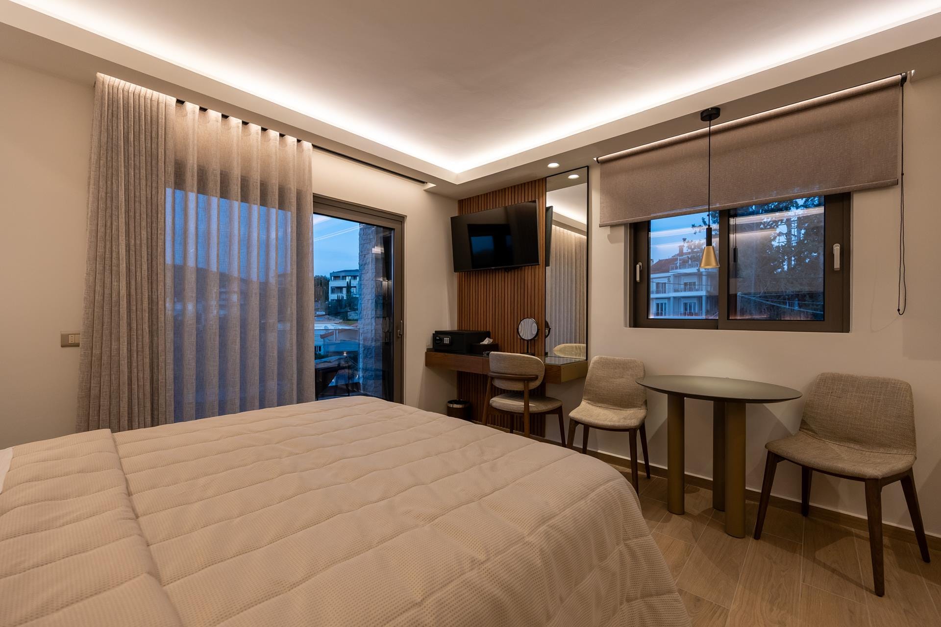 a hotel room with a bed and chairs