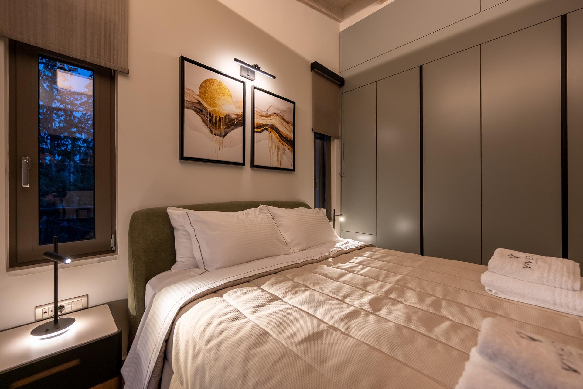 a hotel room with a bed and a lamp