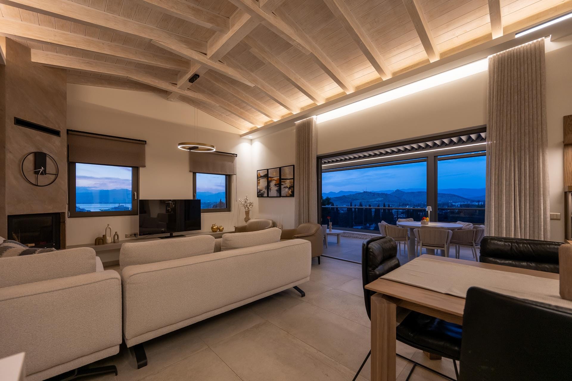 a room with a large window and a couch and a table