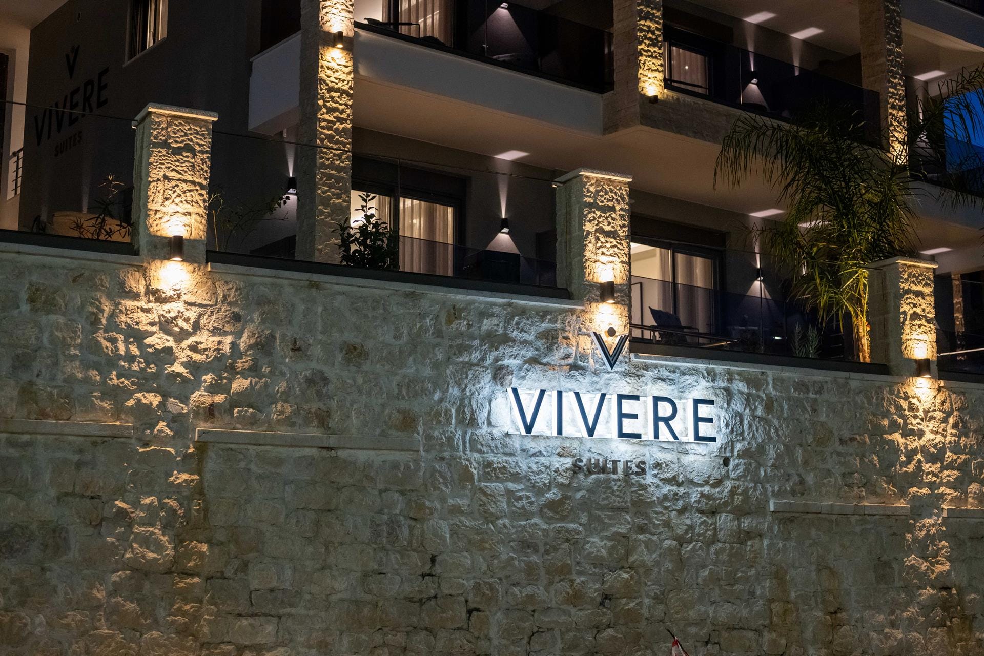 a stone wall with a sign on it