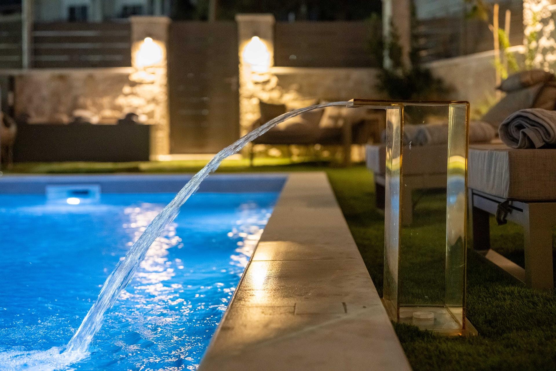 a pool with a deck and chairs