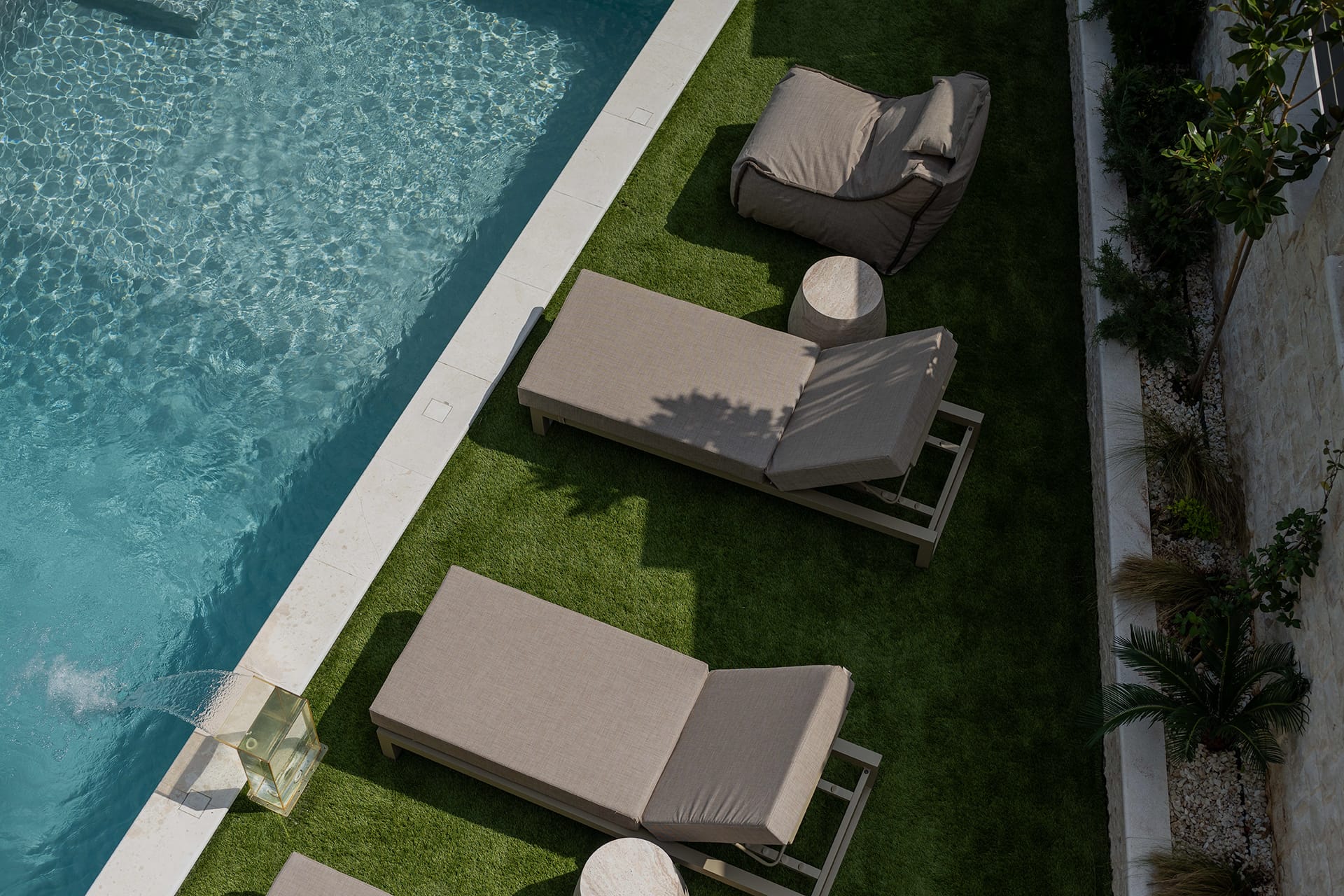 a chair and a table by a pool