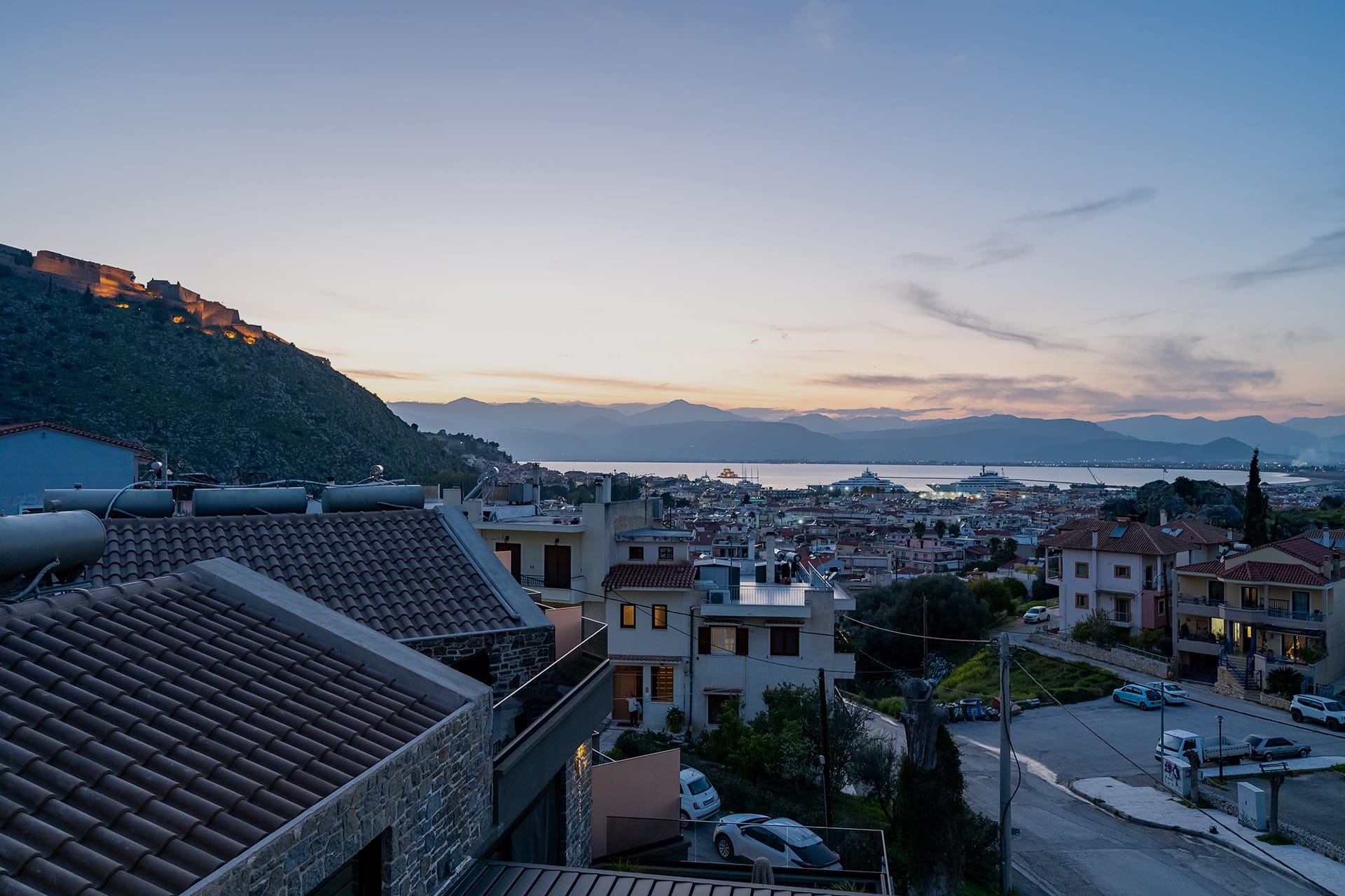 a city with a body of water in the background