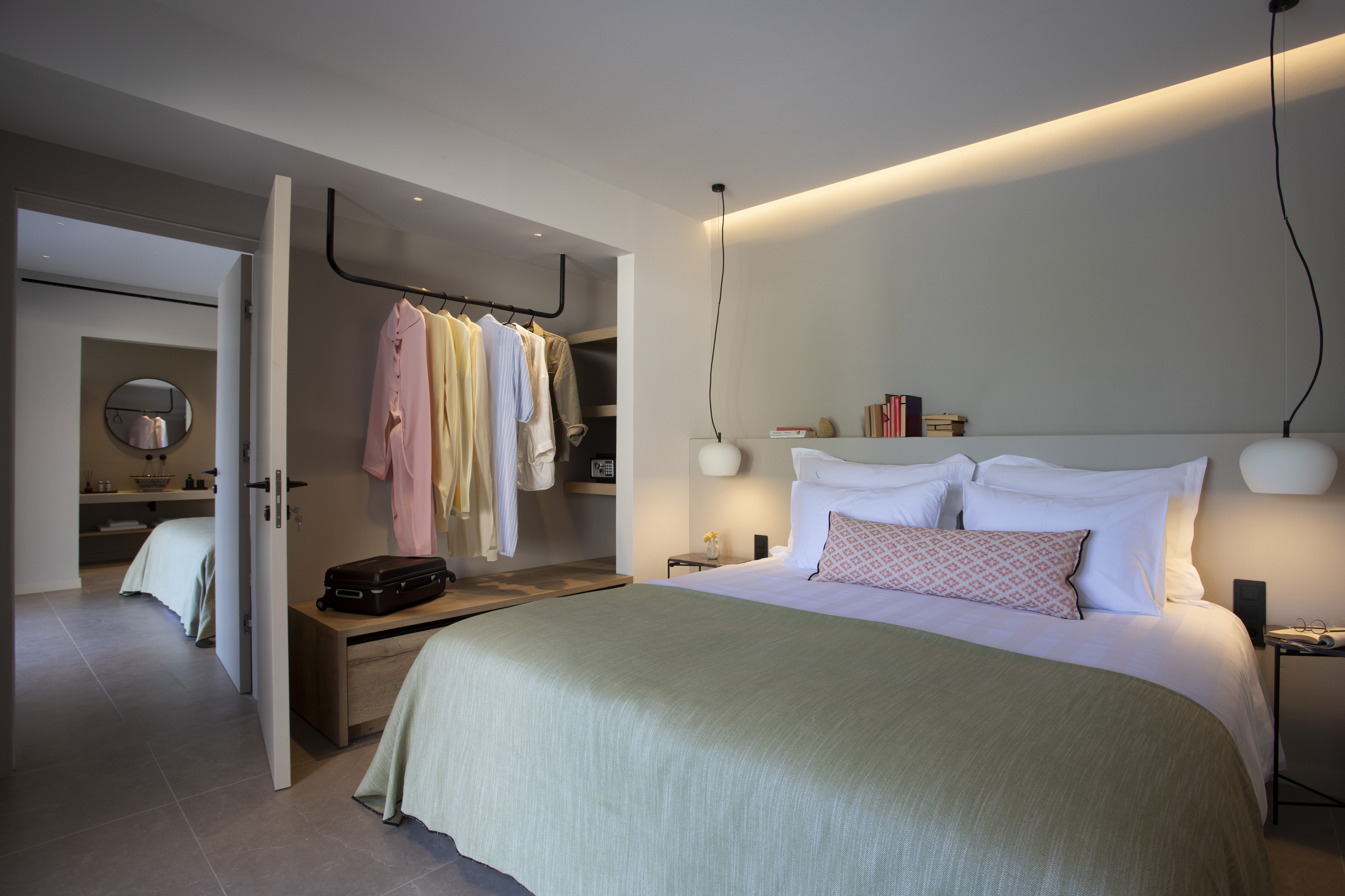 a hotel room with a bed and a mirror