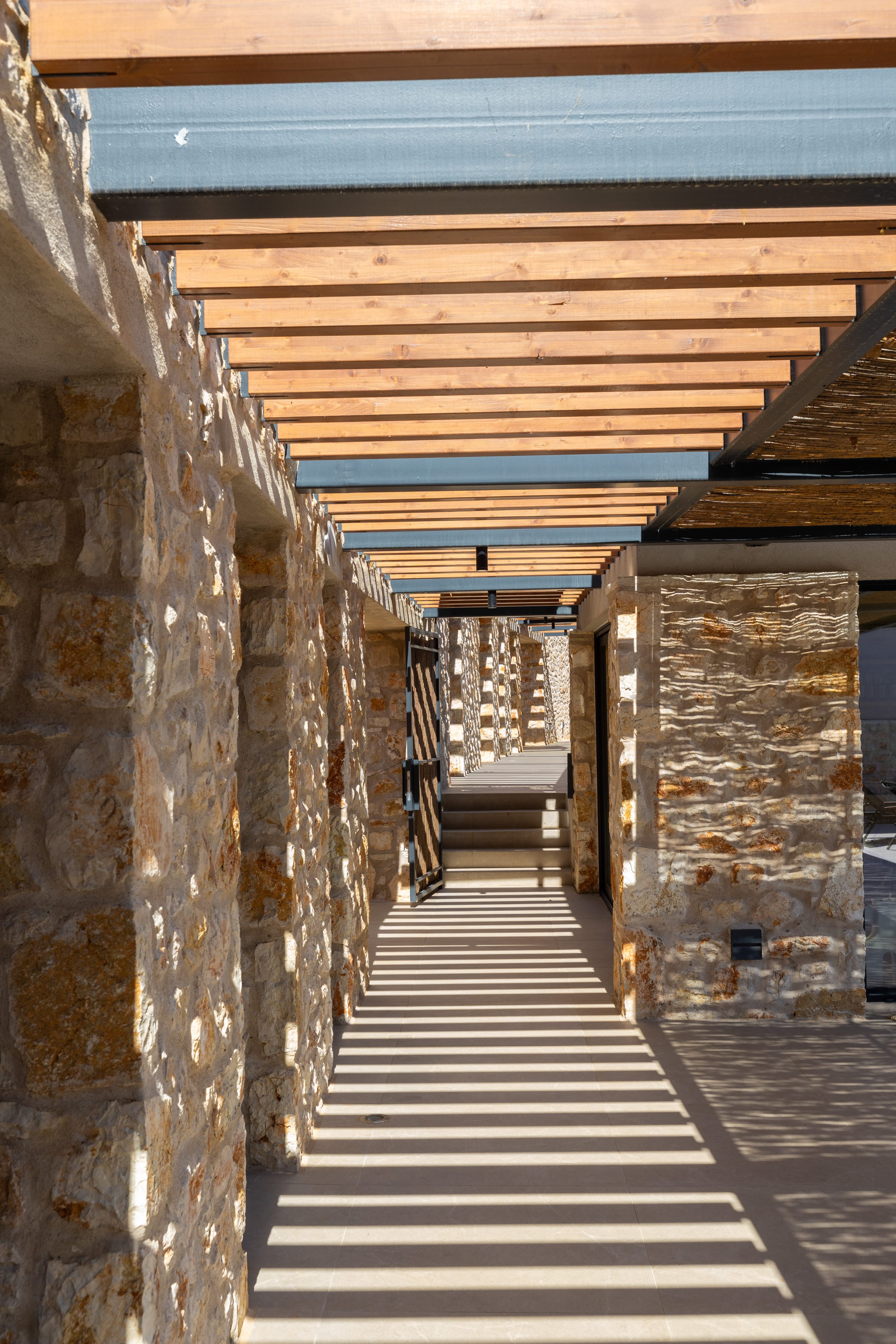 a stone walkway with a stone wall