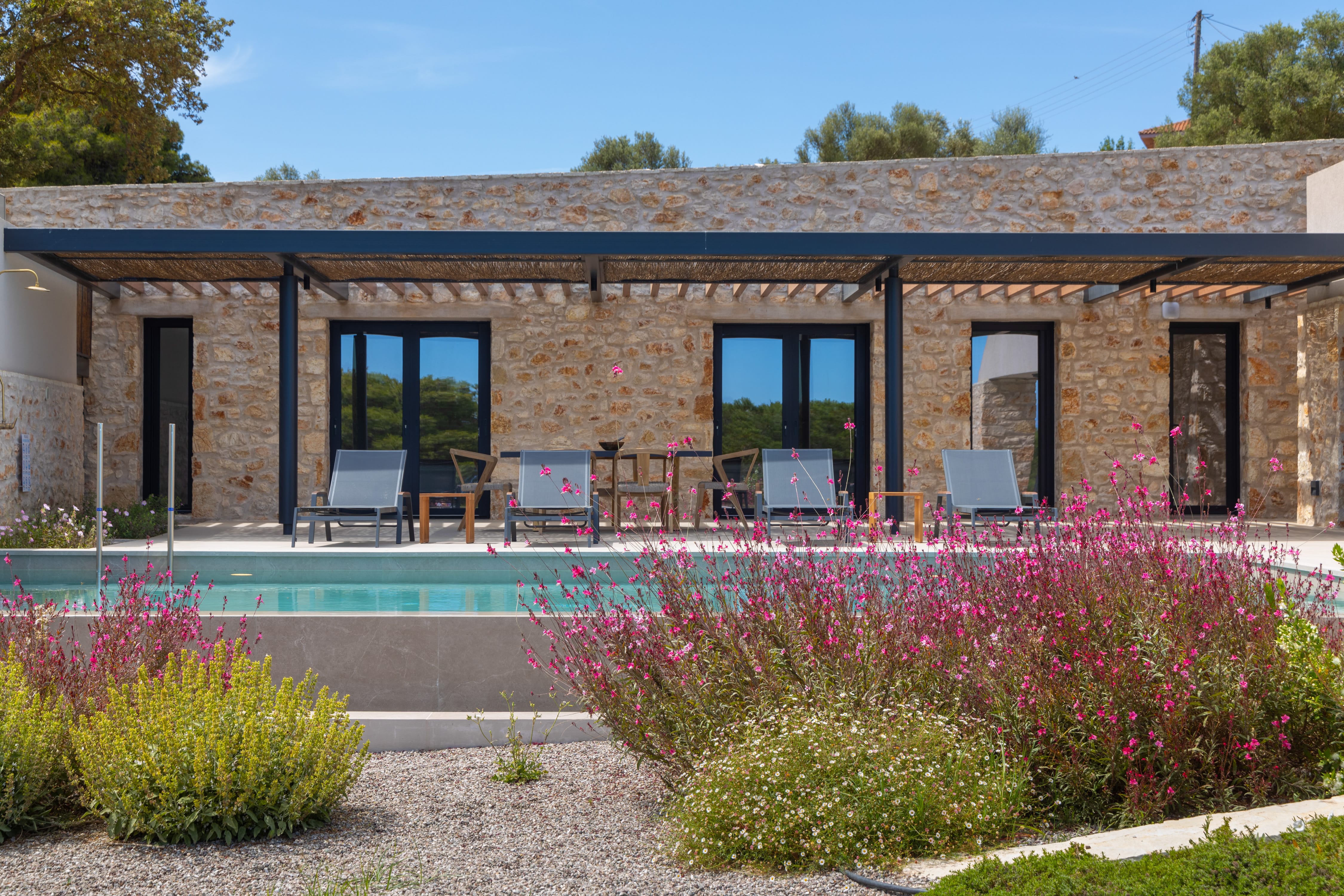 a house with a pool and chairs