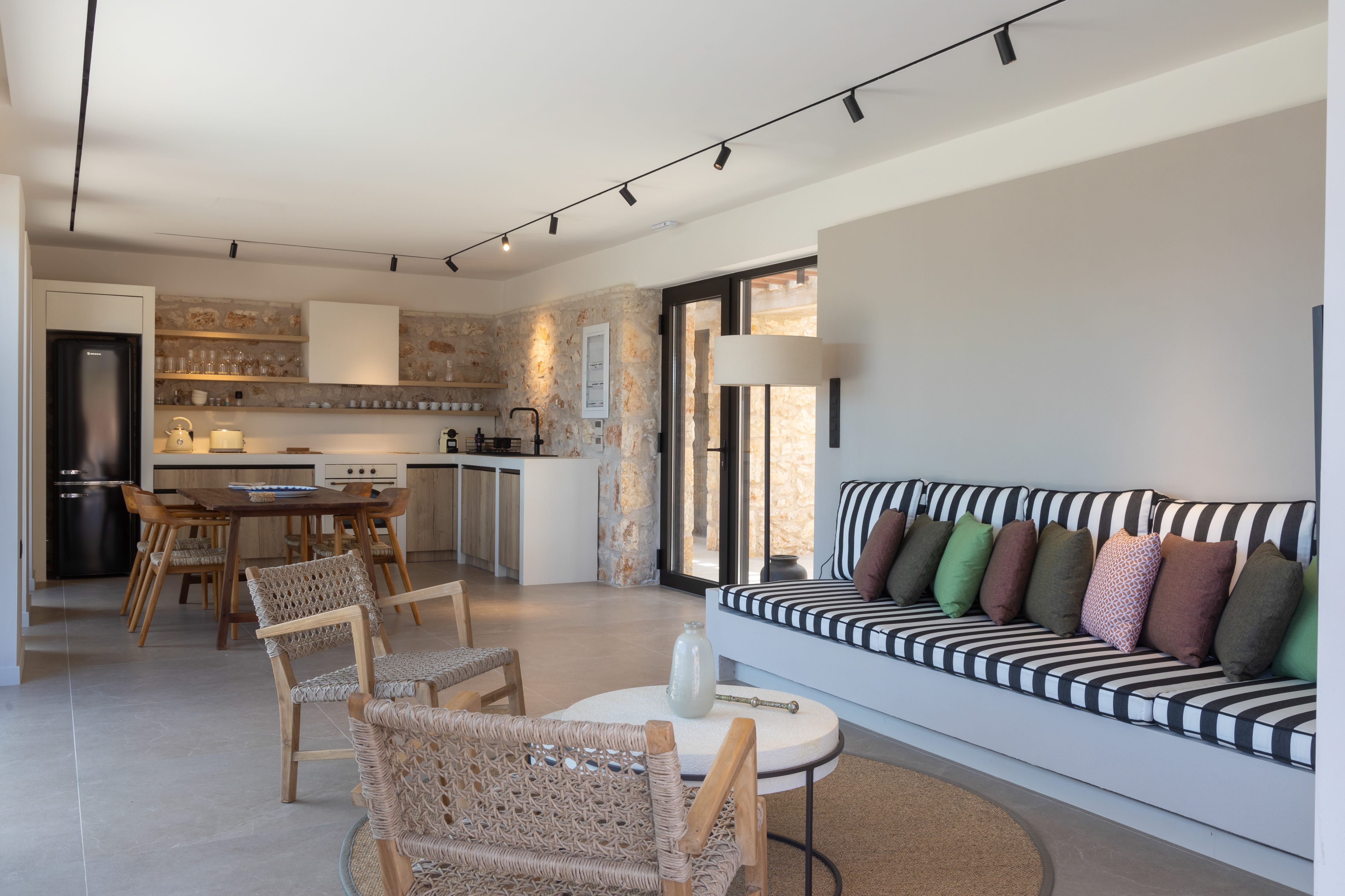 a room with a couch and chairs